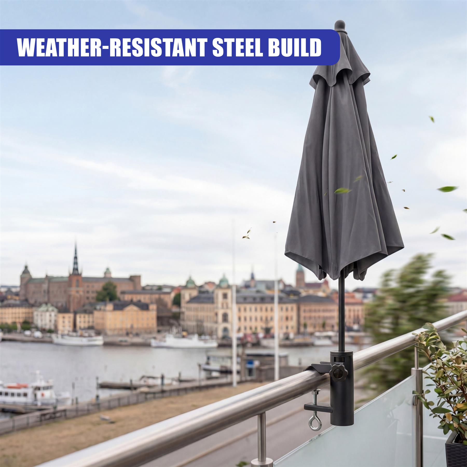 A closed, charcoal grey patio umbrella supported by a sturdy black metal clamp base.