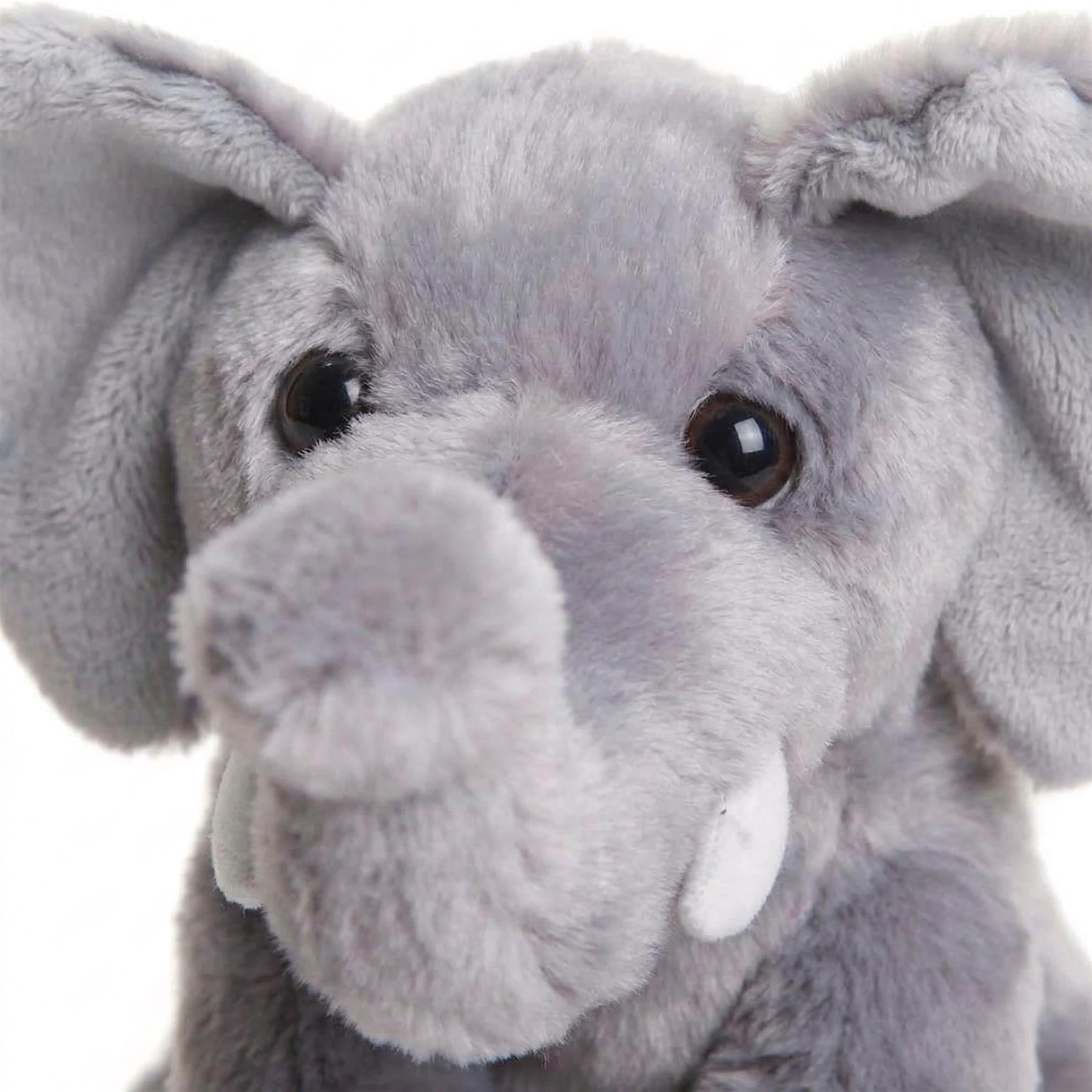 Plush toy of a light gray elephant featuring large ears, trunk, and small visible tusks.