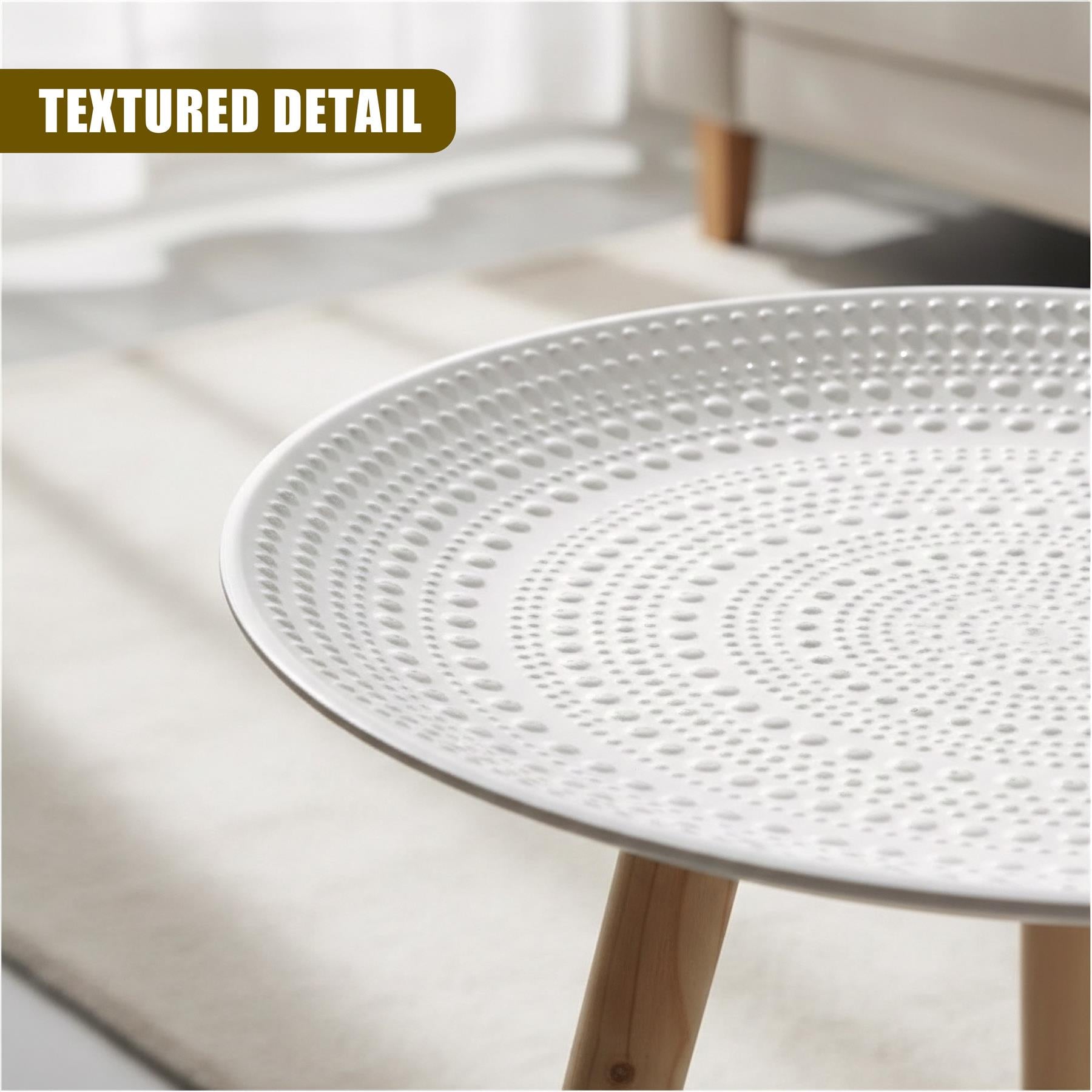 A white round table top with numerous uniform, textured dots arranged in concentric circles.