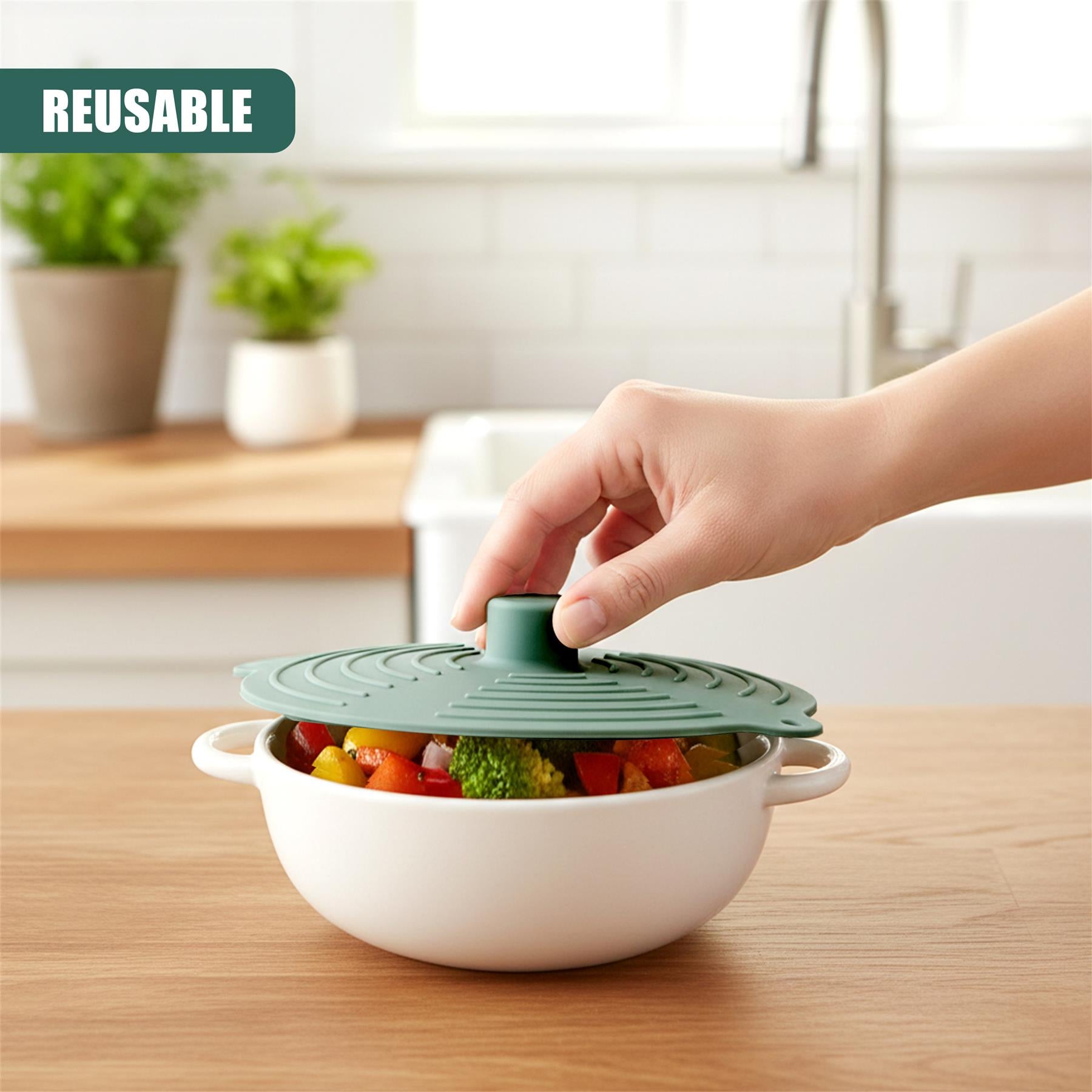 Silicone food cover placed over a white bowl containing colorful chopped vegetables.