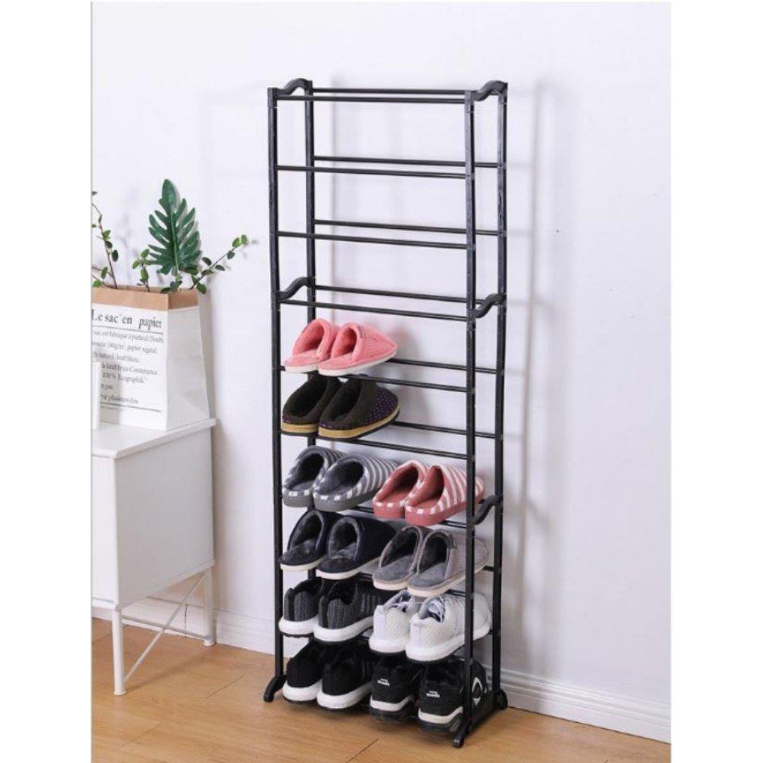 Black tiered shoe rack with shoes on it.