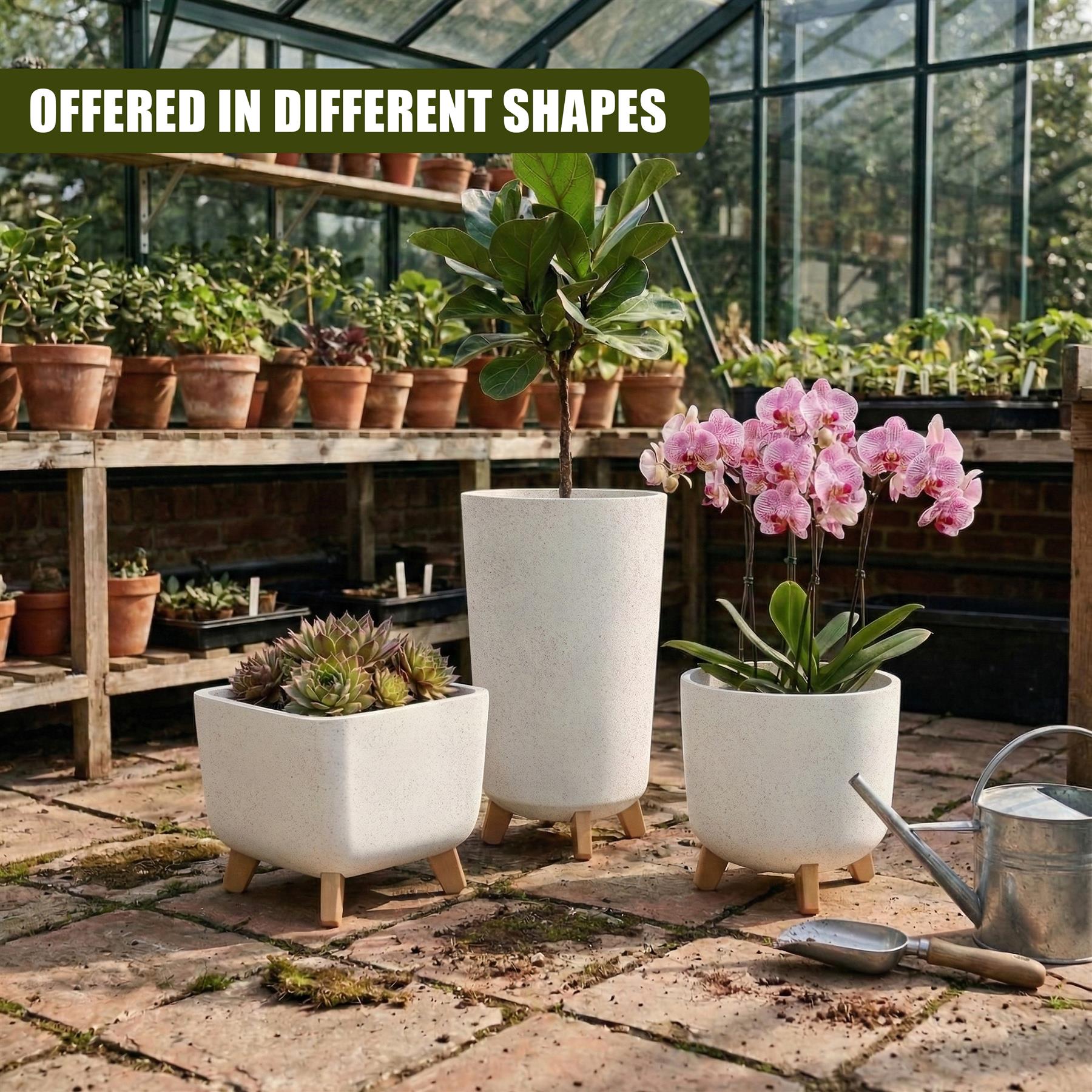 Grouping of three white potted plants with legs sit on a stone floor, surrounded by gardening tools.