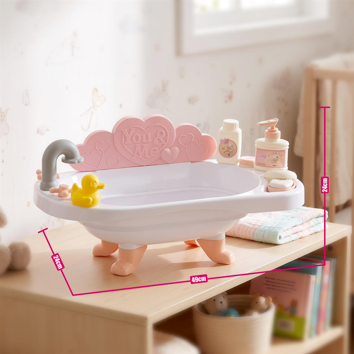 Pink doll bath set with accessories, including a bathtub and bottle, sits on a wooden shelf