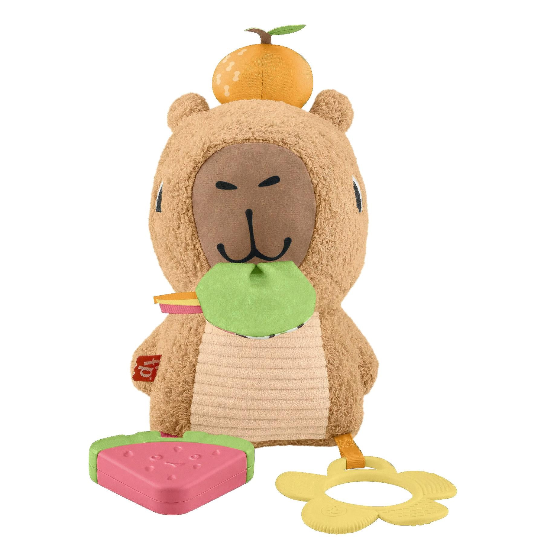 Tan plush toy capybara with an orange headpiece, green snack, pink pad, and yellow sensory ring.