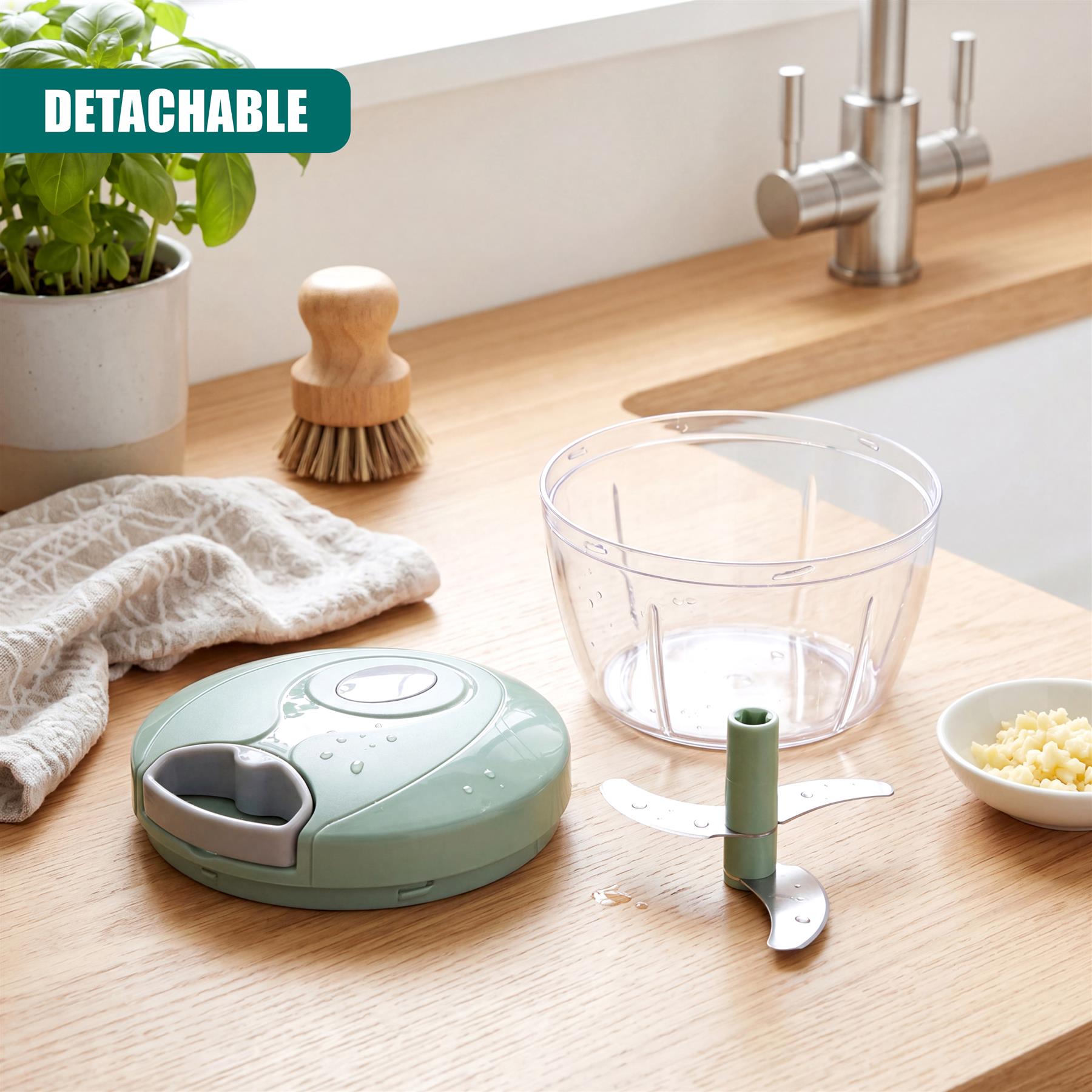 Manual food chopper set includes a green base, clear bowl, and detachable stainless steel blade.