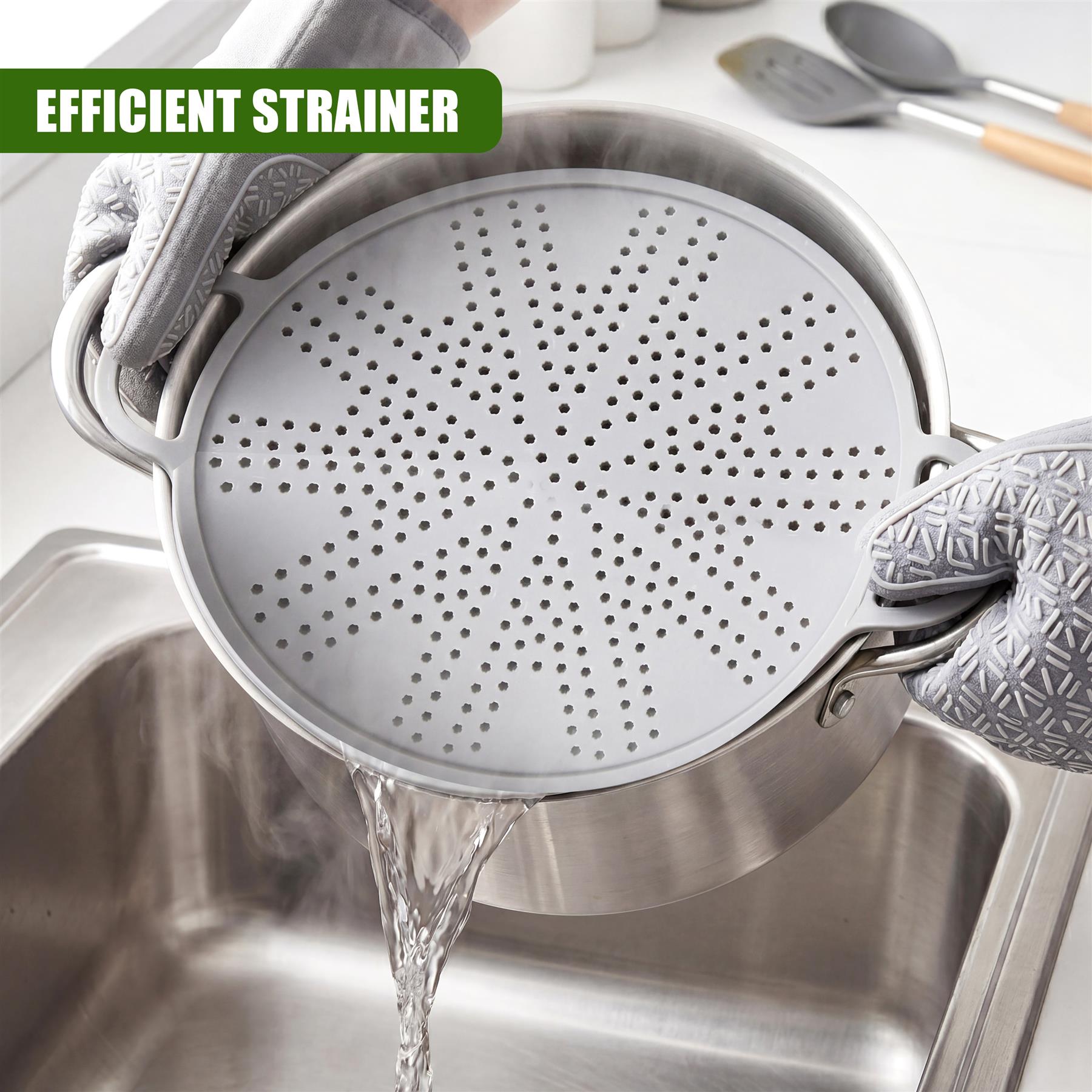 A perforated metal strainer drains liquid into a stainless steel kitchen sink.