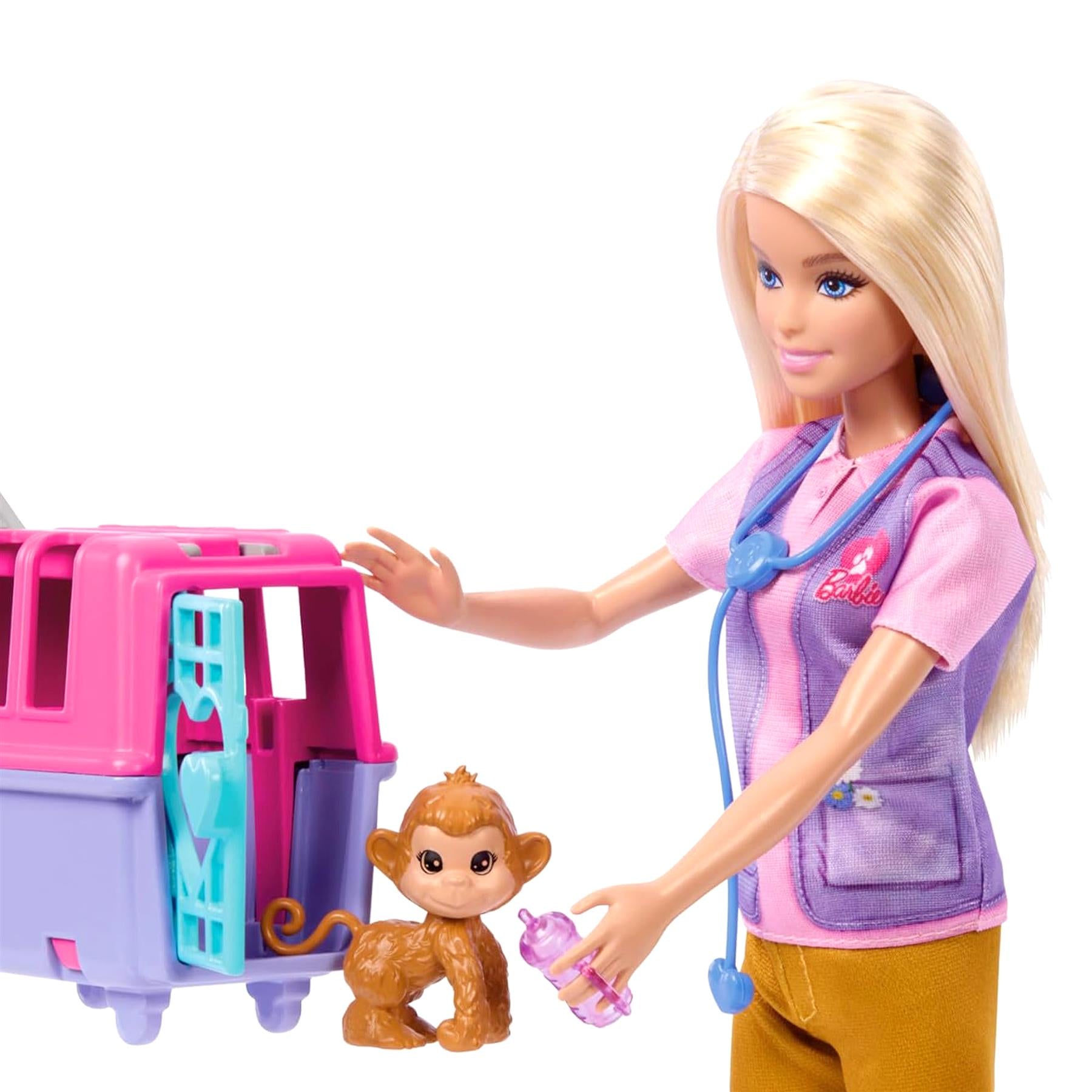 Barbie stands with a rescue playset and holds a small monkey toy accessory.