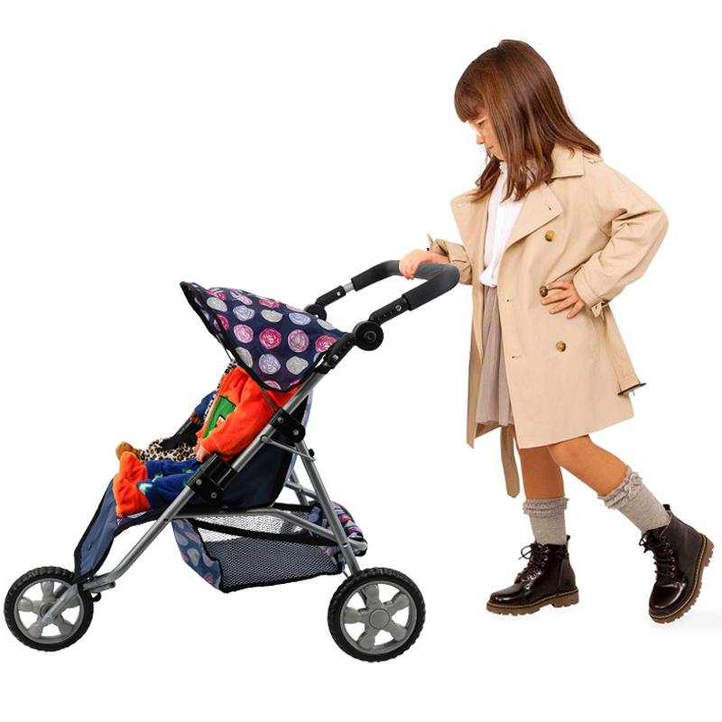 Doll pushing a blue, three-wheeled twin stroller with a patterned fabric canopy.