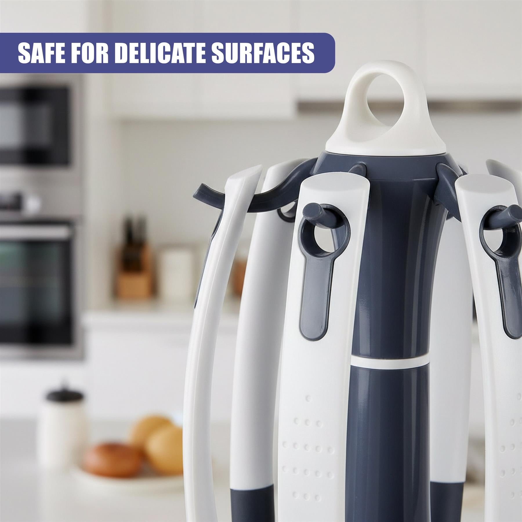 Three kitchen spatulas with white and dark gray handles and perforated grips are displayed.
