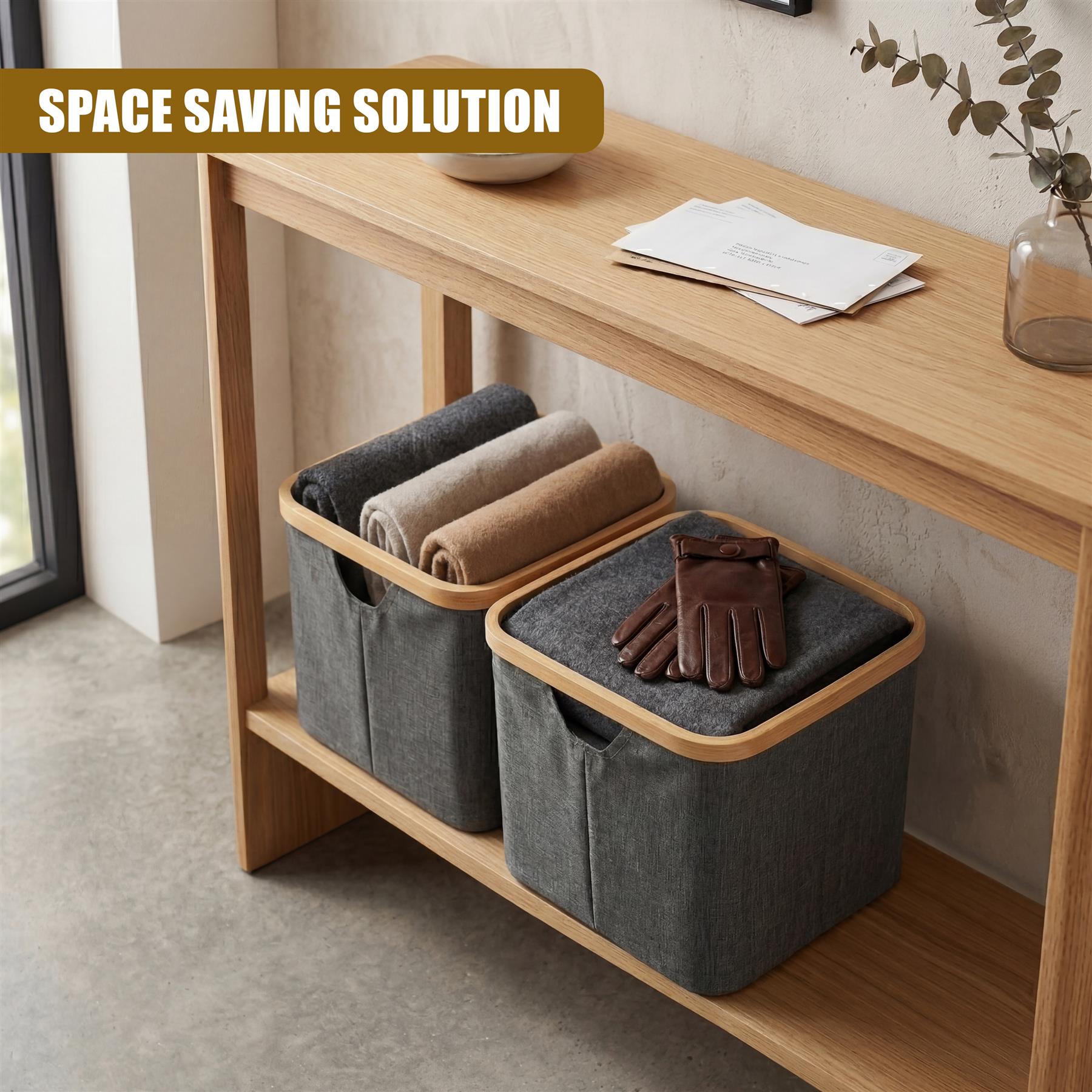 Two square gray textile hampers sit on a wooden shelf with rolled linens and folded gloves.