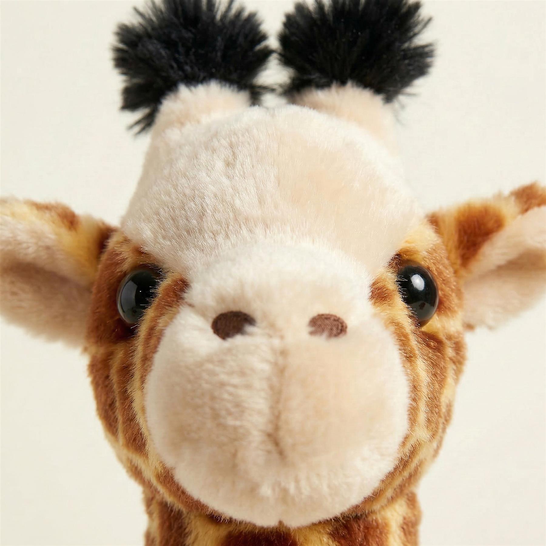 Brown and cream plush giraffe head with spotted fur, a muzzle, and two attached black pom-poms.