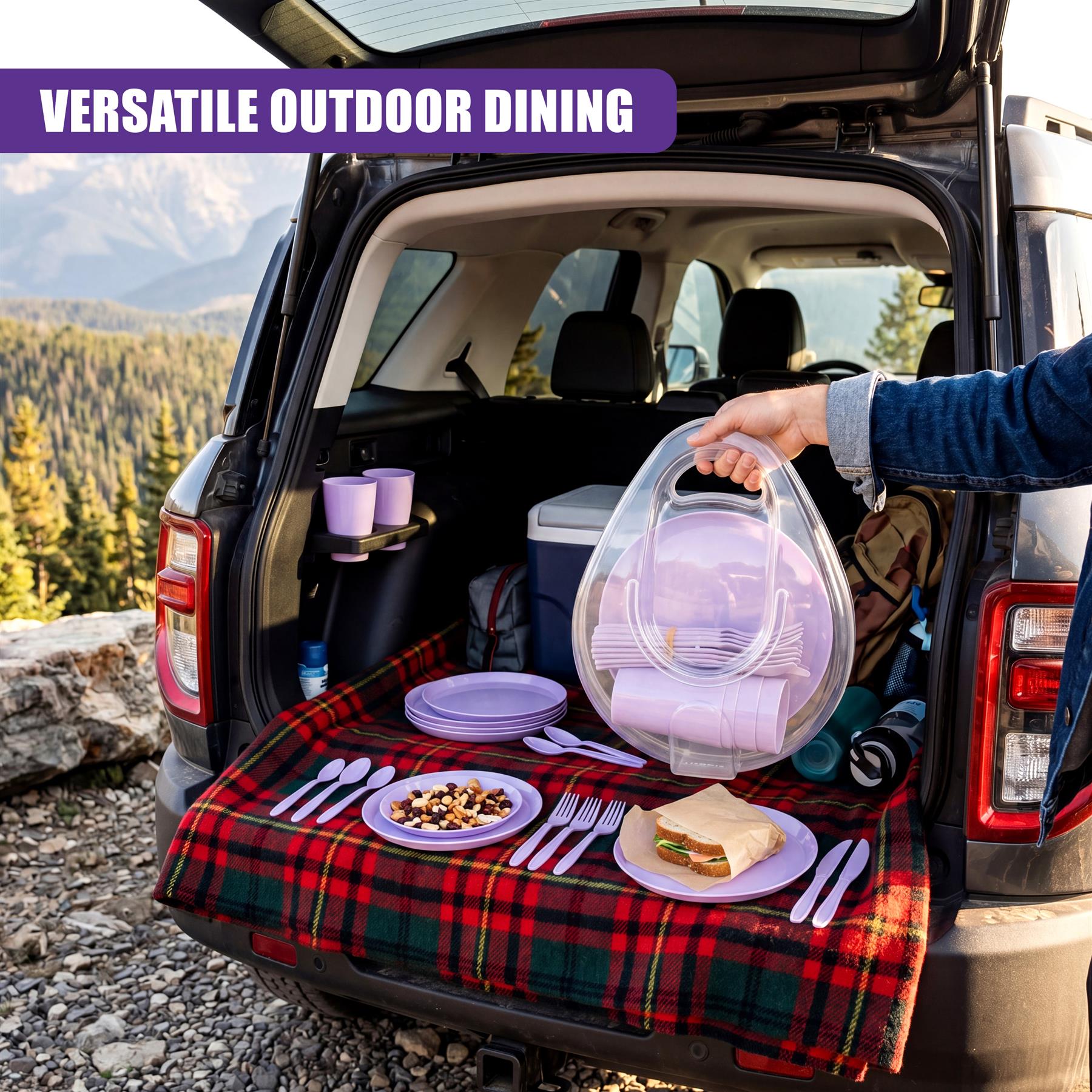 Purple picnic tableware, plates, and utensils are set on a plaid blanket inside a car trunk.
