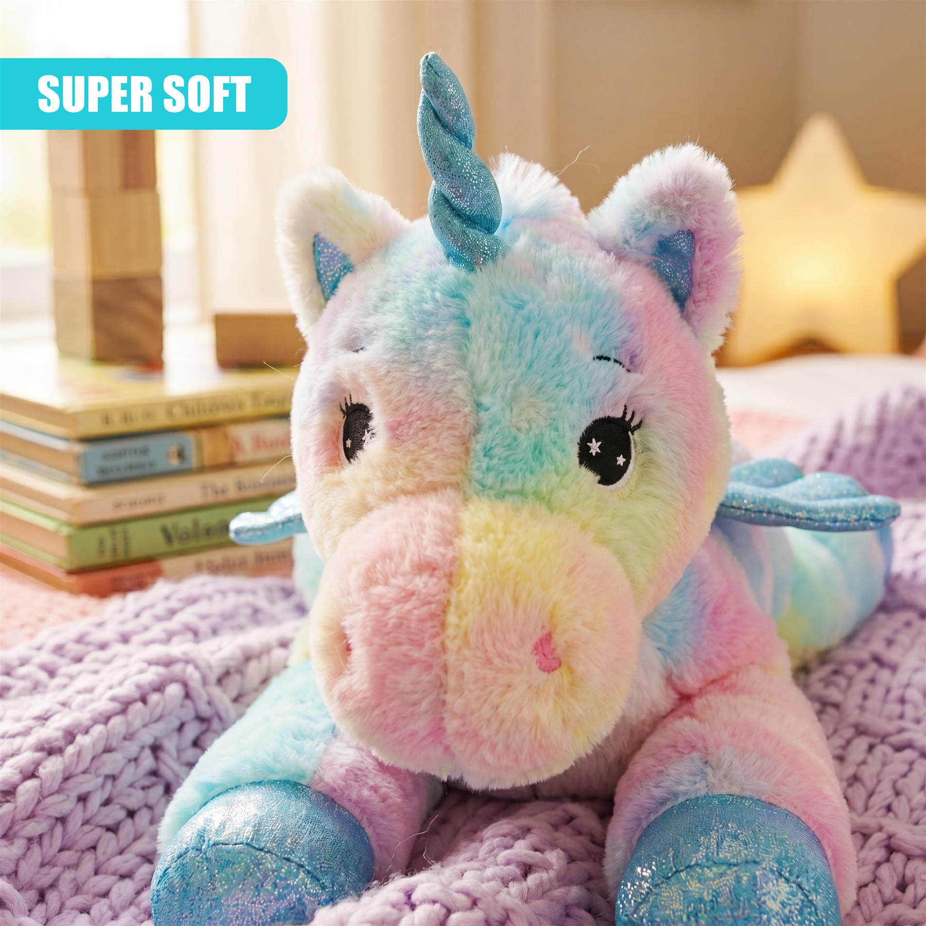 Light blue and pink unicorn plush toy with blue glitter hooves on purple blanket.