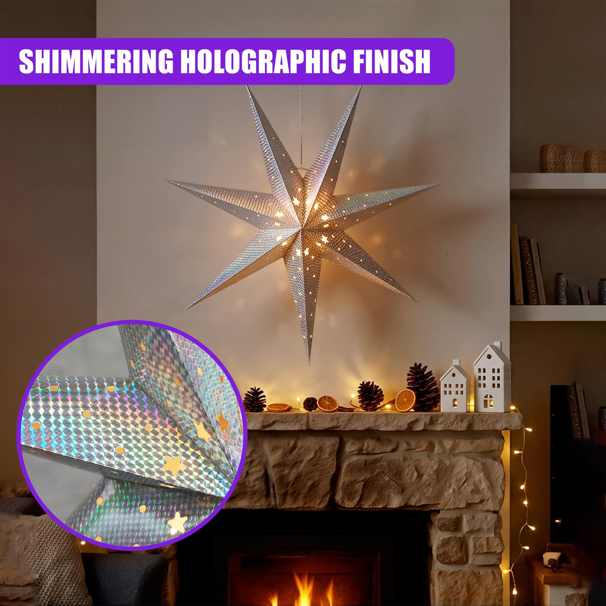 Silver LED paper star lantern with holographic finish, displayed in a cosy living room setting