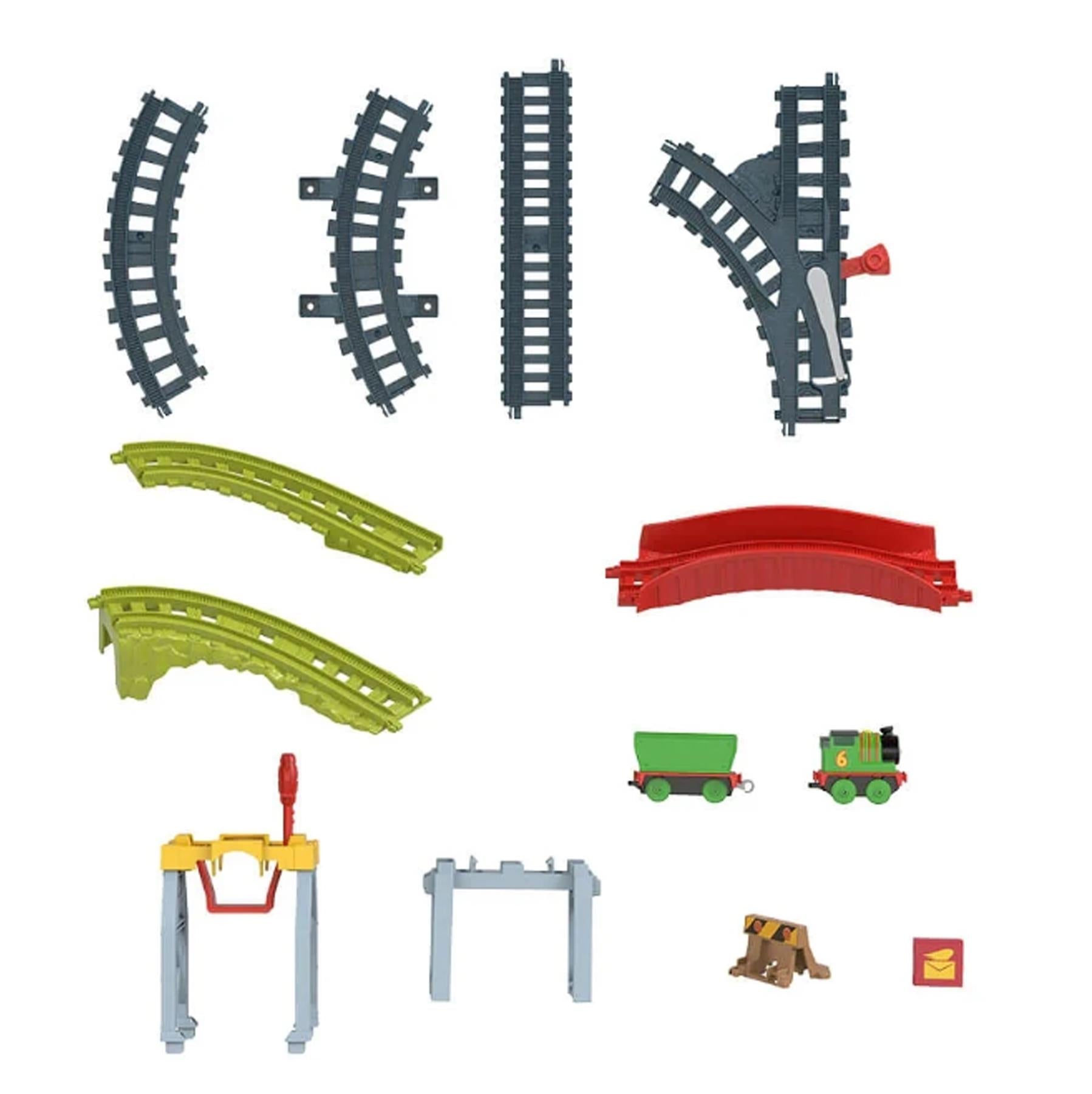 Assorted toy train tracks, including curves, straight segments, loops, and small accompanying train wagons.