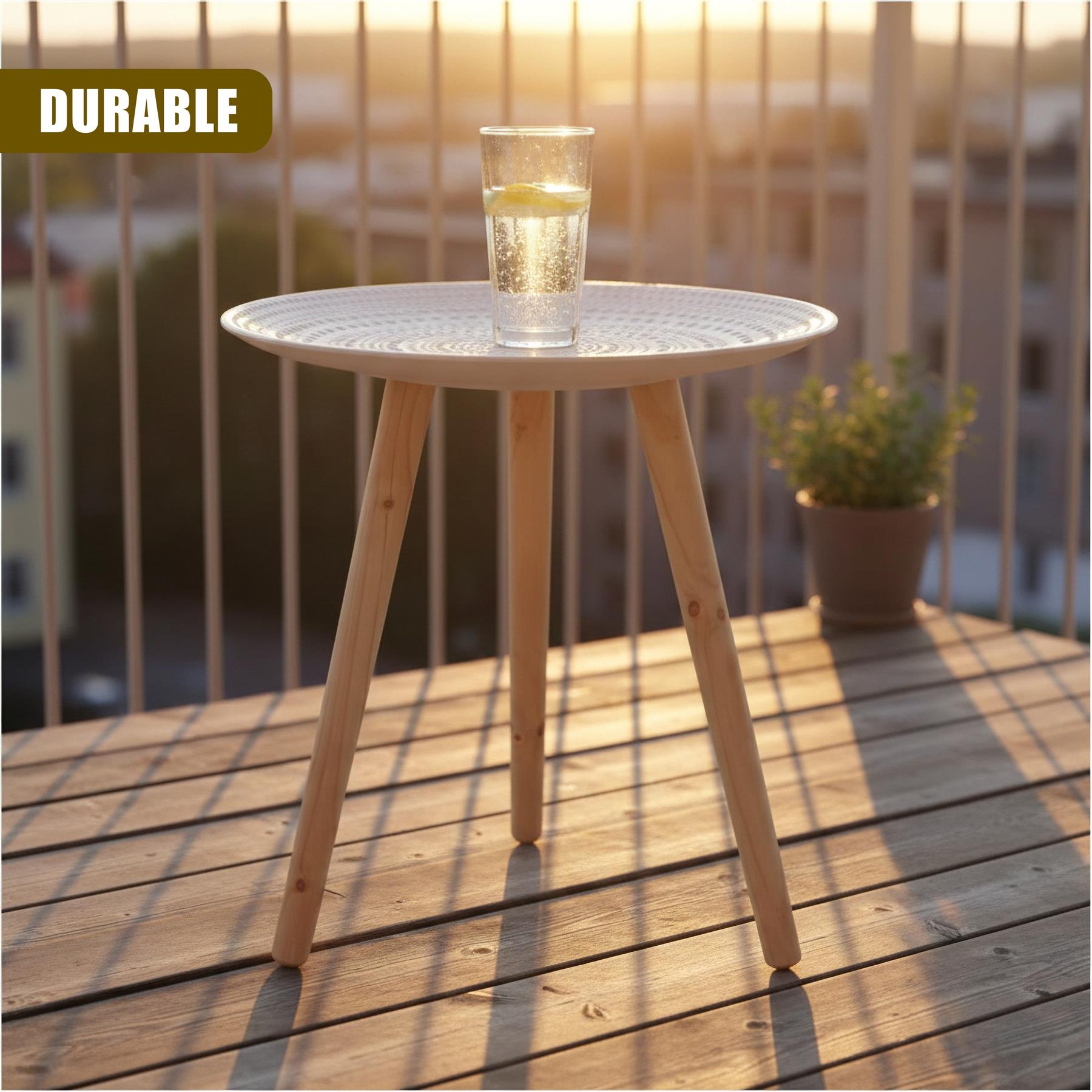 Round white side table with tapered wooden legs, displaying a glass of liquid on a wooden deck.