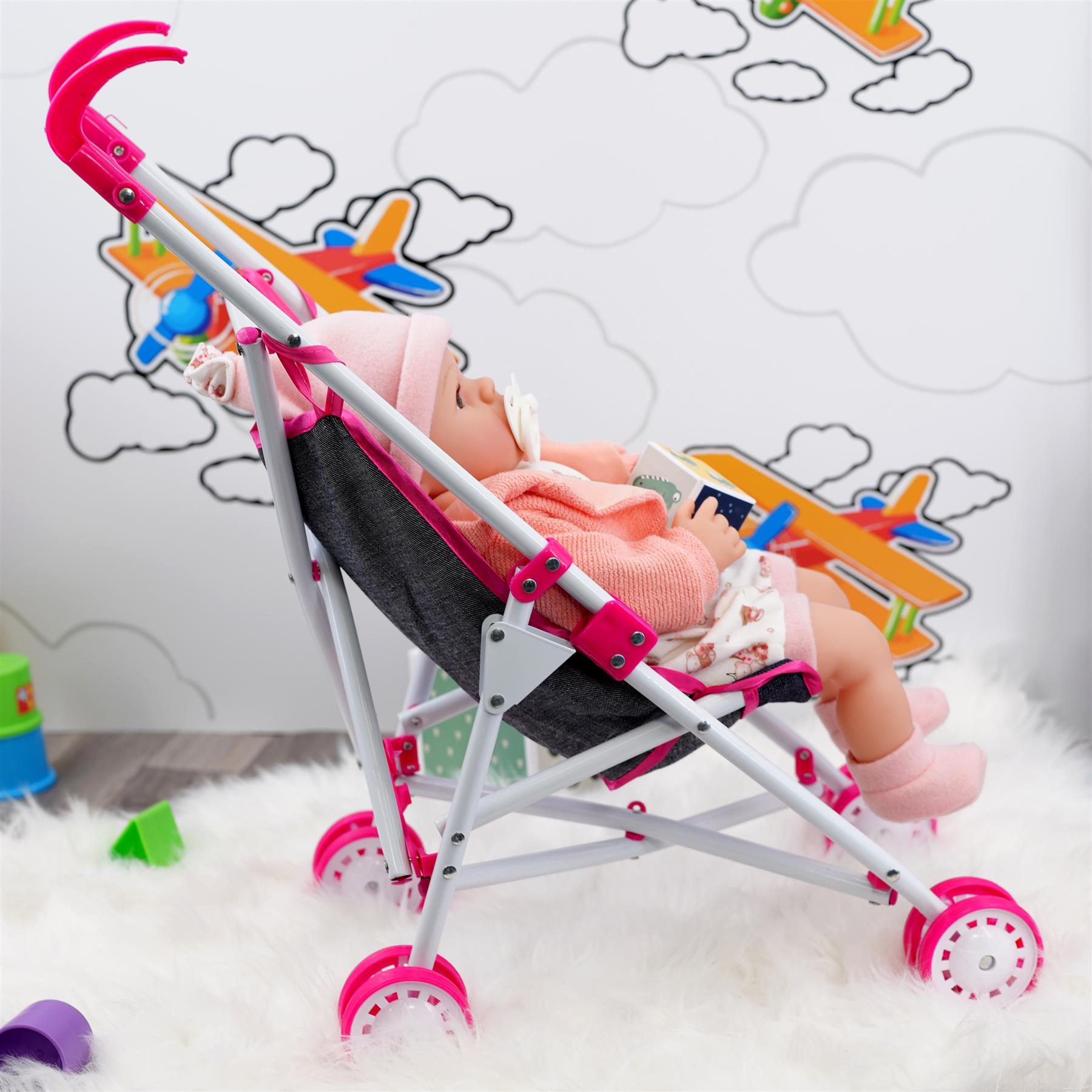 This is a Bibi Doll Pink foldable stroller from theMagictoyshop. It's a perfect accessory for any dollhouse, with its light pink color and sturdy design. The stroller folds easily for convenient storage when not in use.