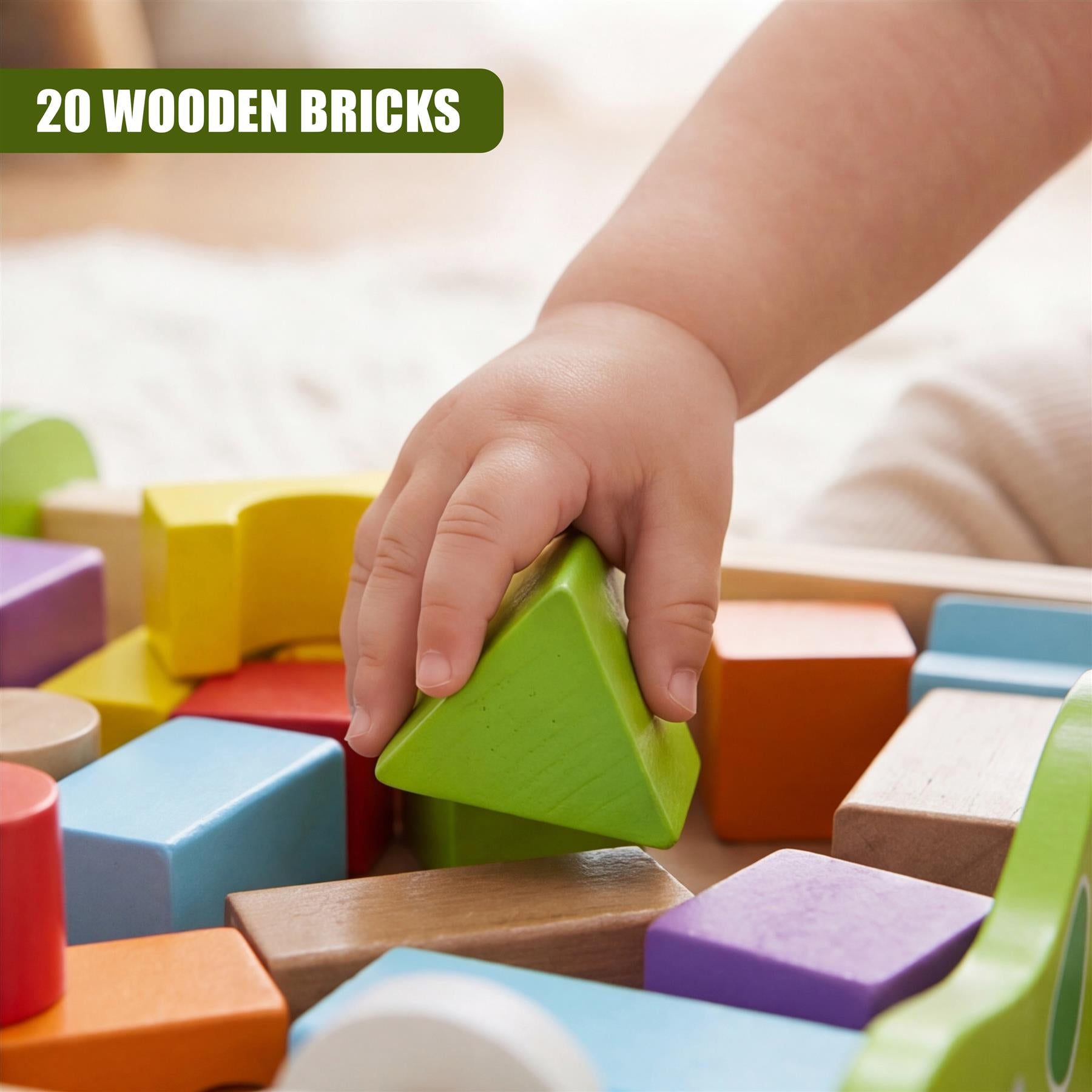 A small hand grips a bright green wooden triangular block among various colored wooden building blocks.