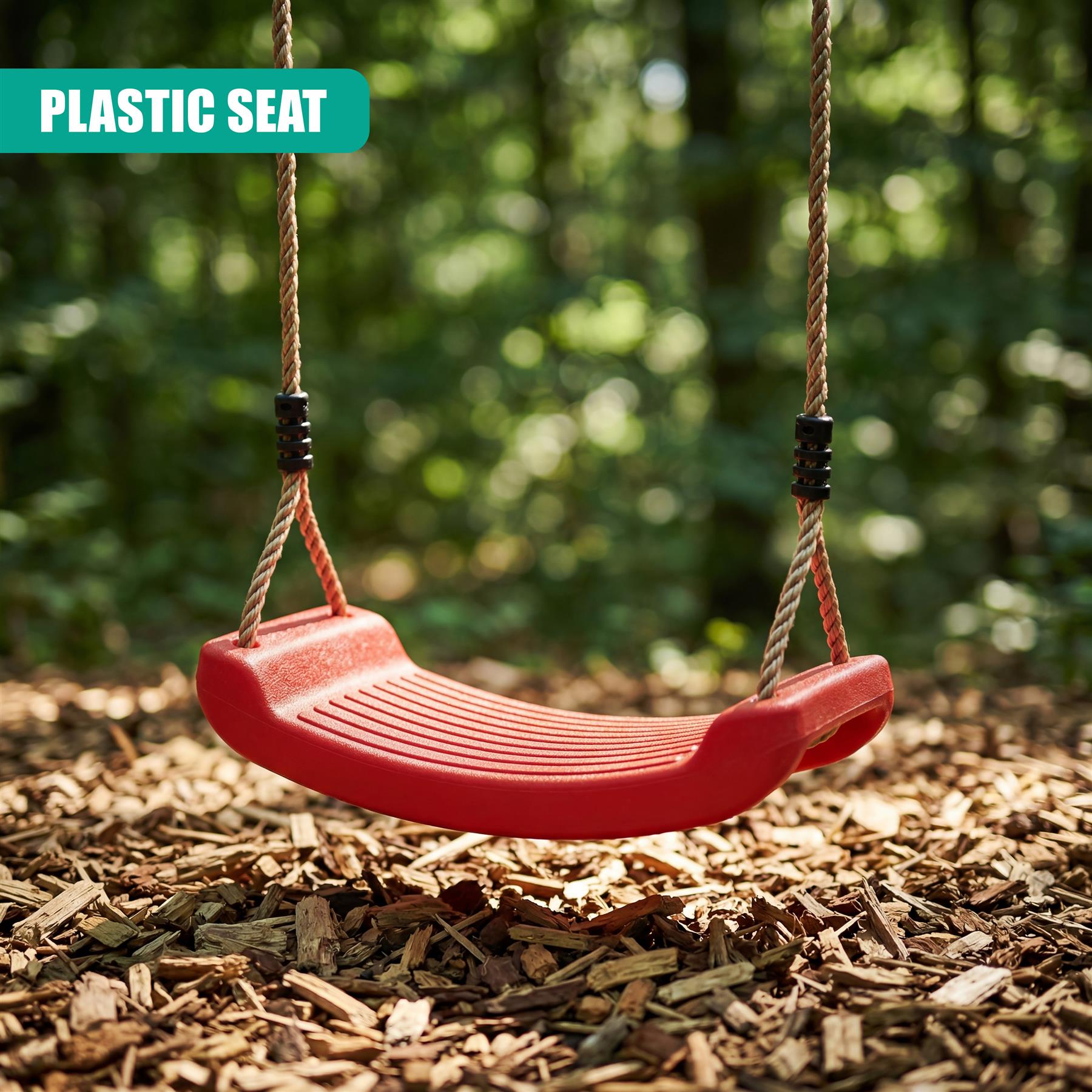 Red plastic swing seat hangs from rope chains in a wooded outdoor setting.