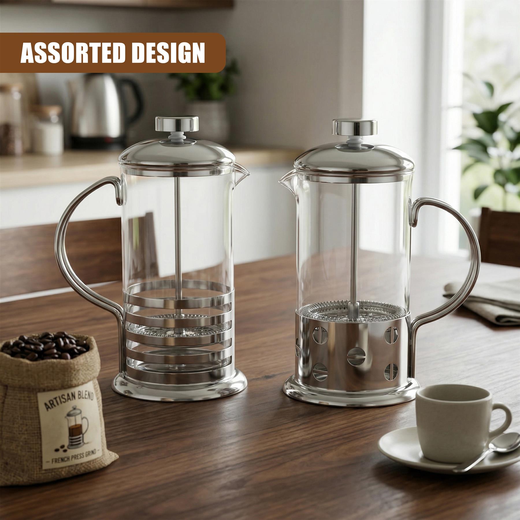Two glass cafetiere presses with silver plungers rest on a wooden surface next to coffee beans.