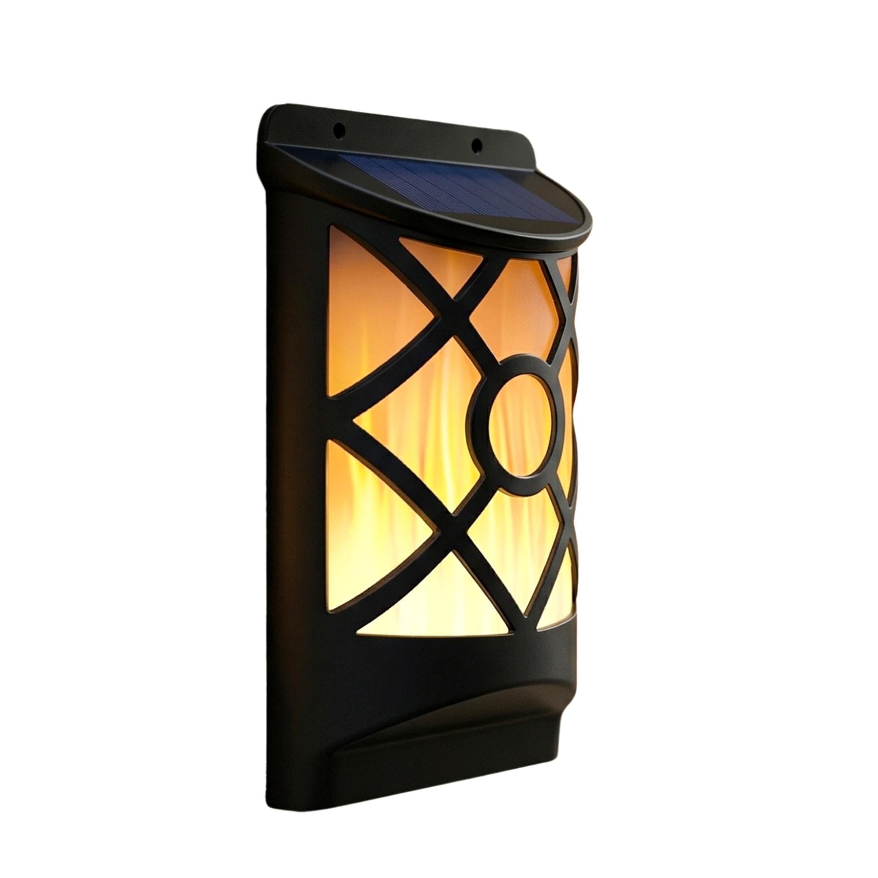 Vertical black outdoor wall lantern with decorative cutouts and a simulated internal warm orange glow.