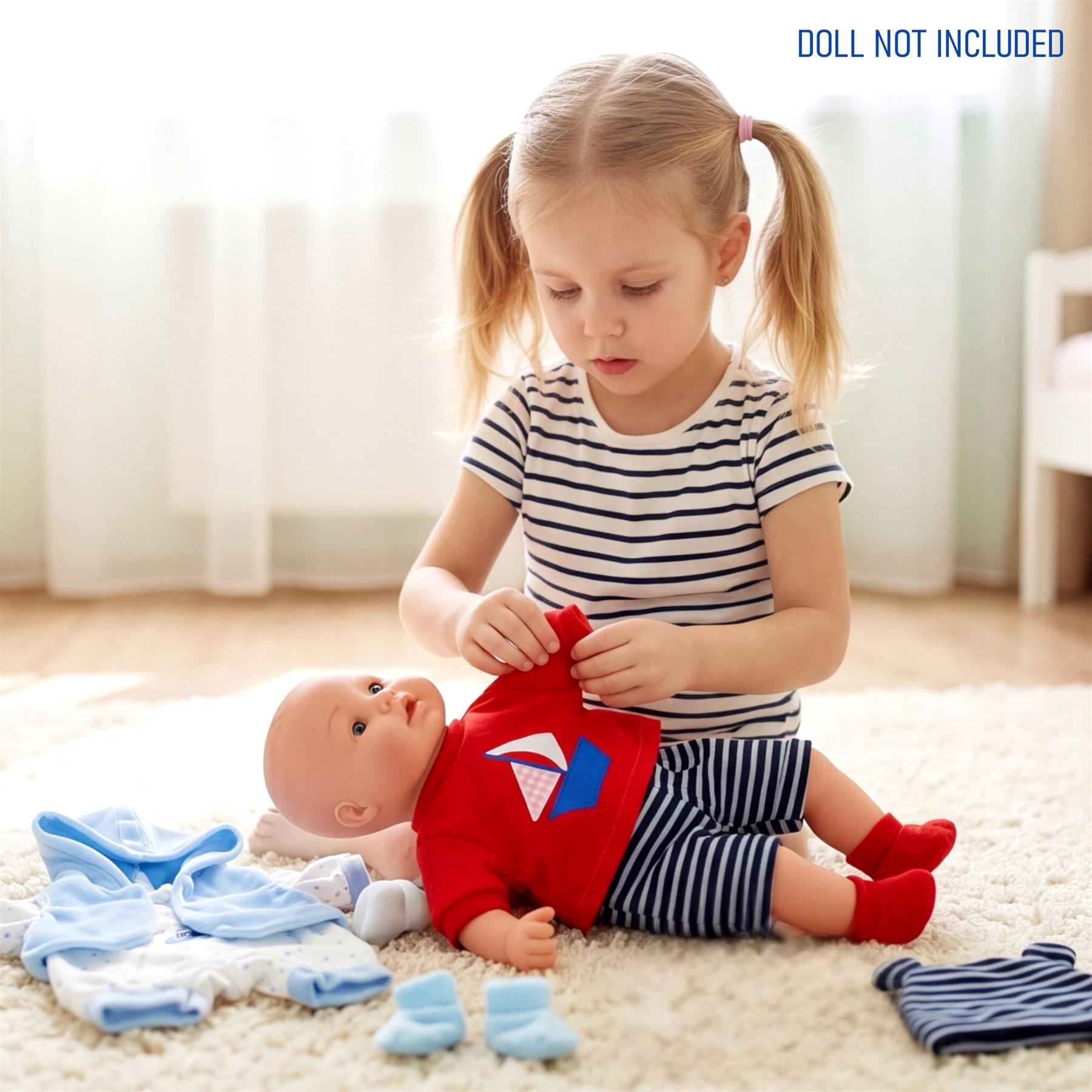 Girl dressing a doll using red and blue outfits, with additional clothing items visible nearby.