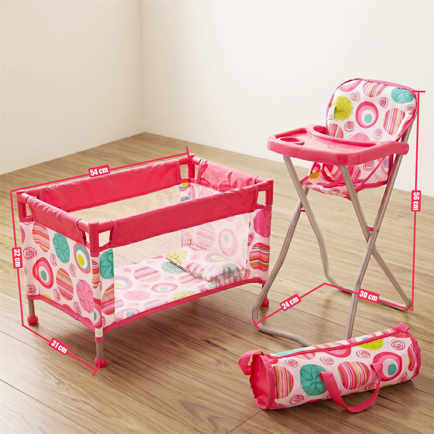 Pink travel baby set consisting of a cot, matching high chair, and carrying bag displayed on a wood floor.
