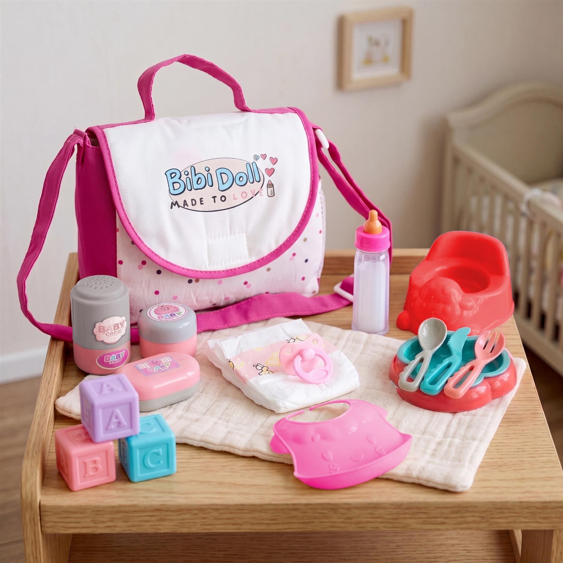 Pink diaper bag includes toys and accessories: pacifier, bottles, blocks, and toy feeding set.