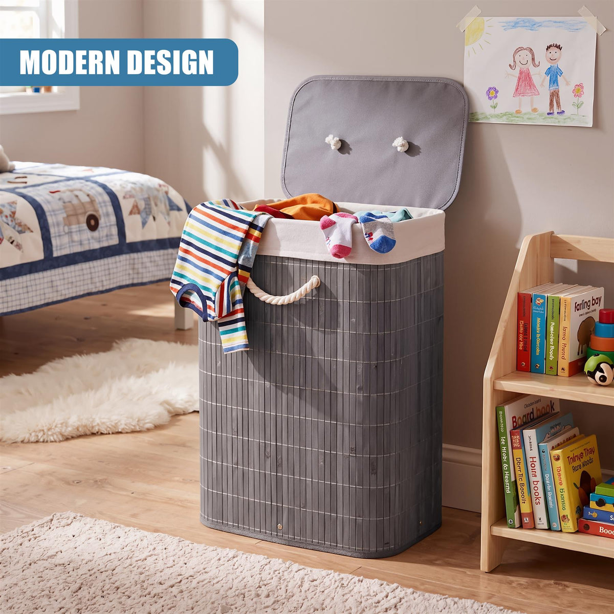 Grey bamboo laundry hamper with lid, featuring a fabric liner, sits on a wooden floor in a child’s room