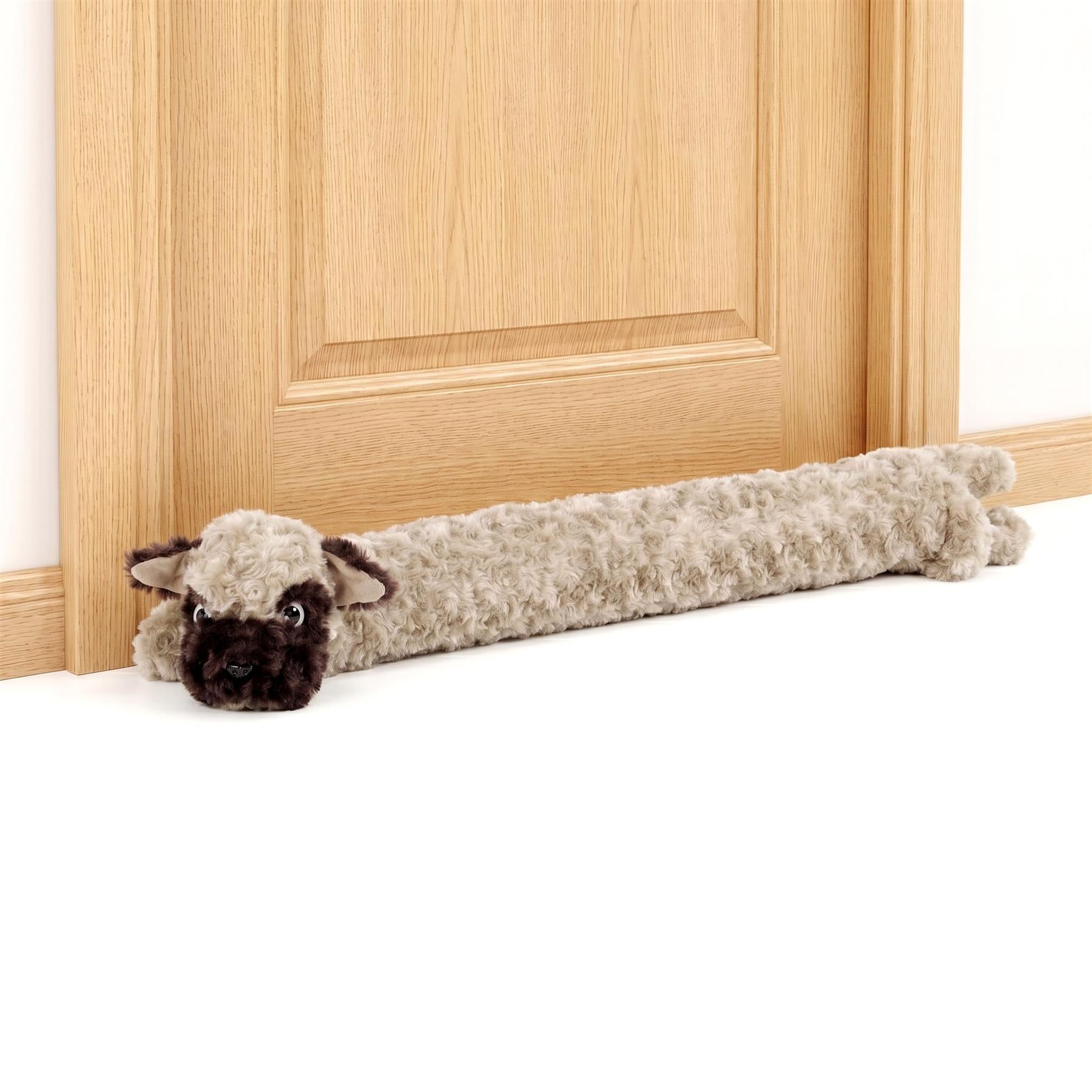 Fuzzy, brown draught excluder shaped like a sheep rests horizontally against light wood paneling.