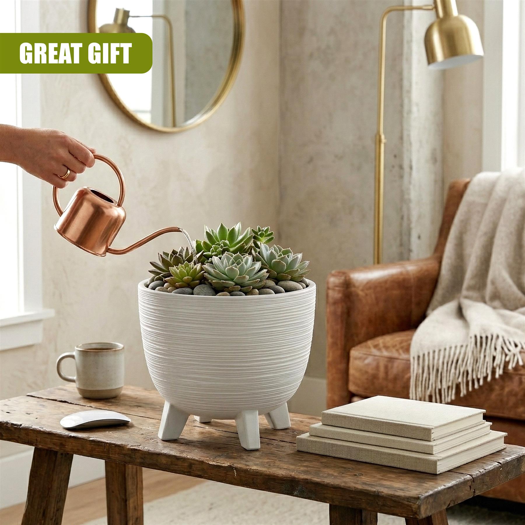 The white, segmented flower pot with short legs contains green succulents on a wooden table.