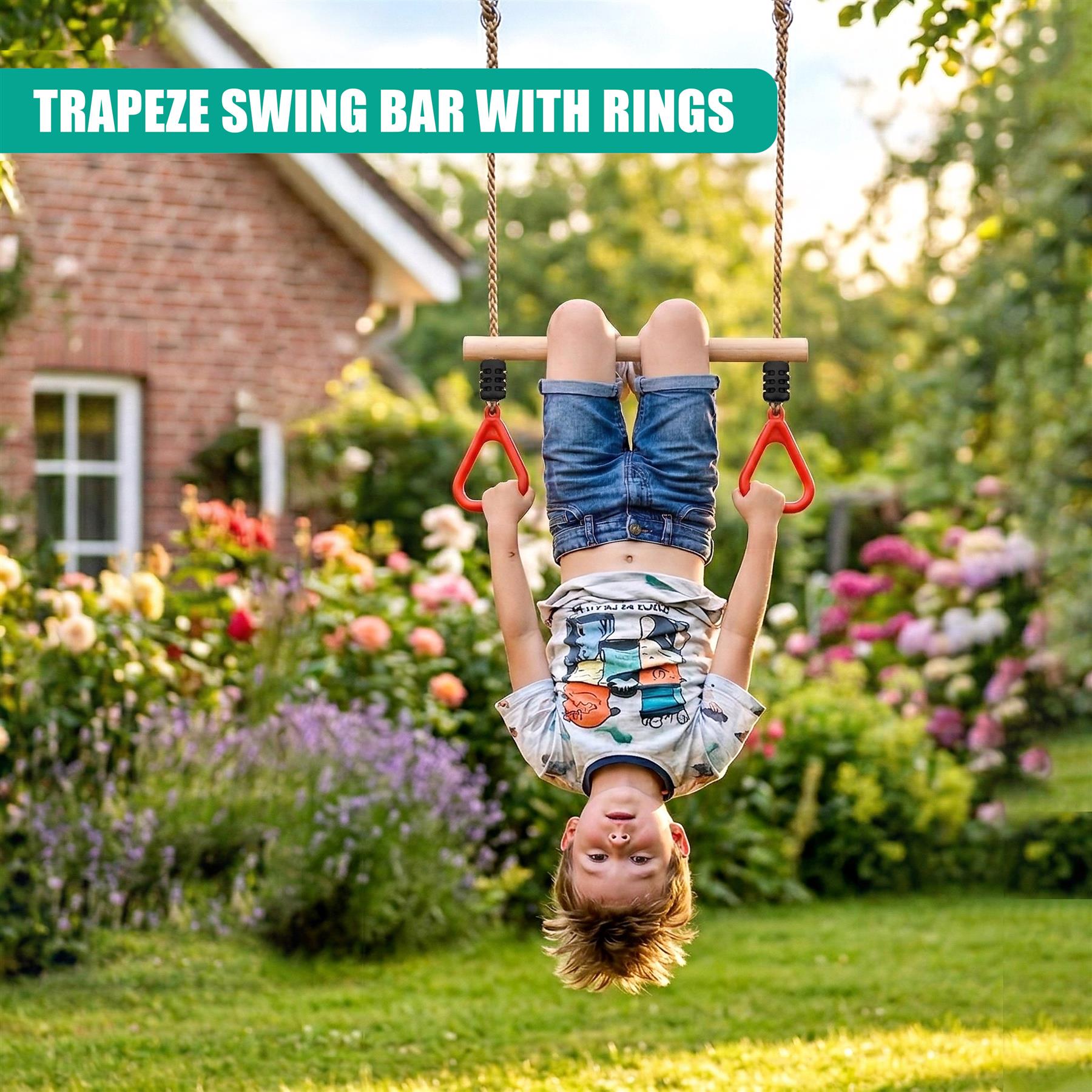 Young child hangs from a trapeze swing bar using attached red rings outdoors in a garden.