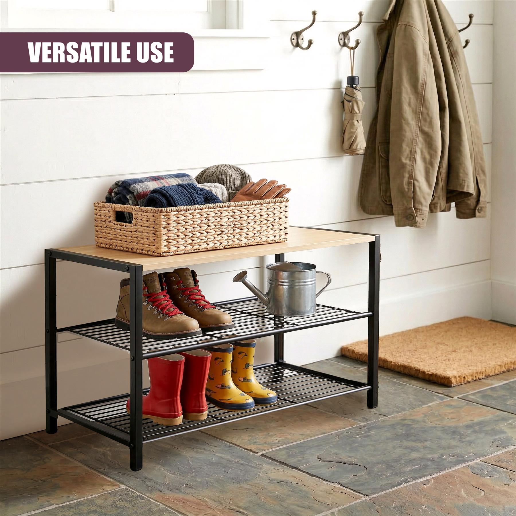 A black, two-tiered shoe rack displaying various boots, sneakers, and a woven basket.