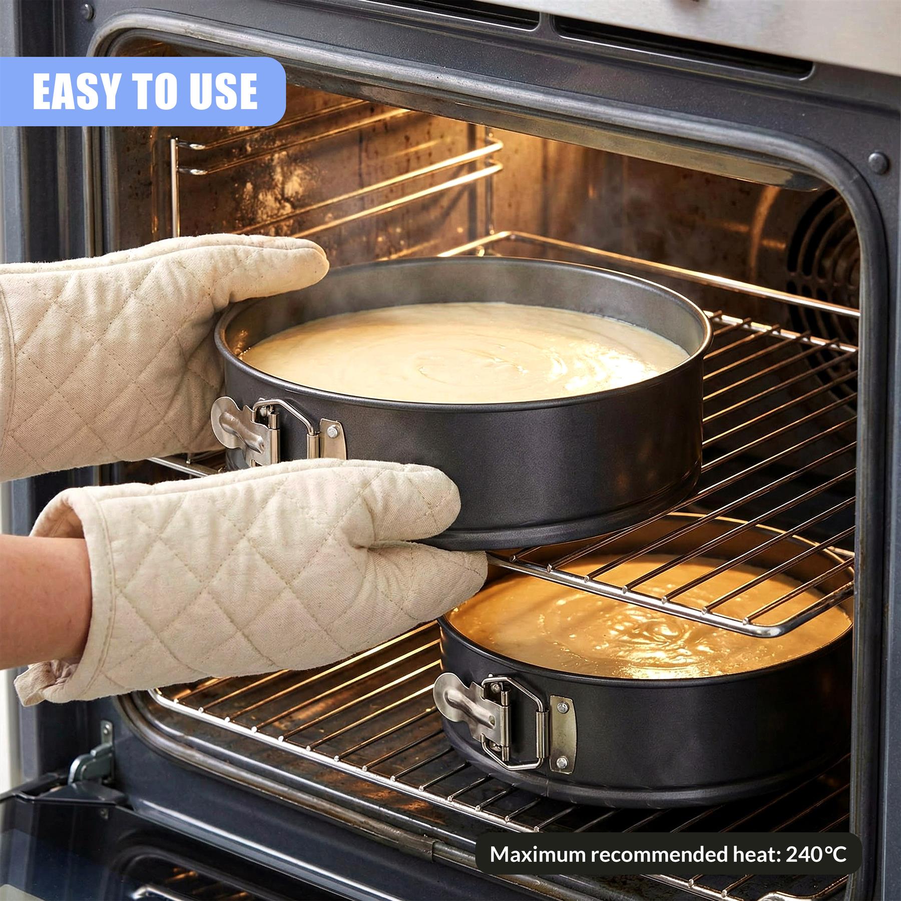 Hands handle two filled springform pans, moving them through an opened oven cavity.