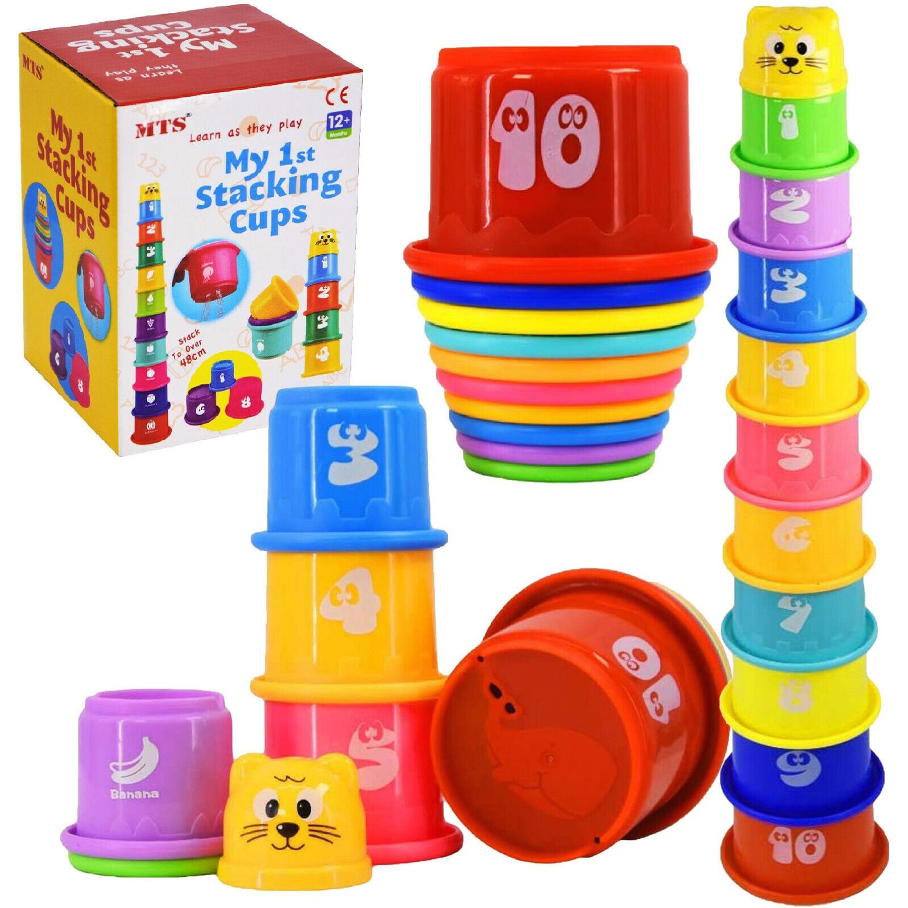 The set includes a box, various colored stacking cups, numbered large cups, and small animal shapes.