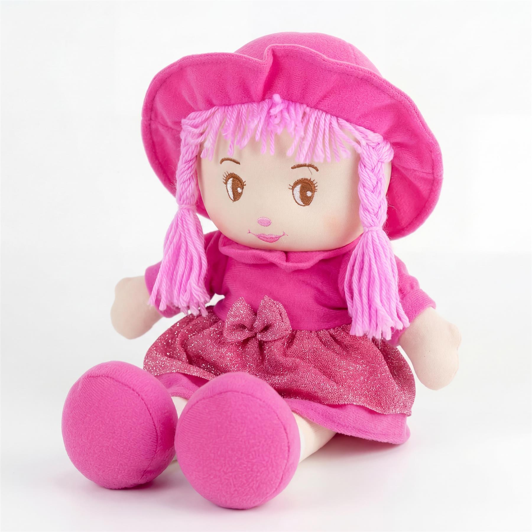 Pink rag doll with yarn hair wearing a wide-brimmed hat and sparkly pink layered dress.