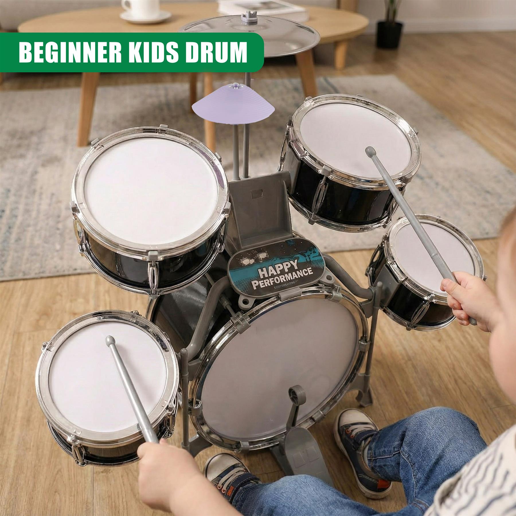 A child's hands are seen playing a drum set, with drumsticks held in each hand. The drum set is black with white drumheads, and has a blue and black "Happy Performance" drumhead in the center. The drum set is on a light wood floor, with a rug underneath it. The child is wearing blue jeans and a white and blue striped t-shirt. The room is light and modern, with a coffee table in the background. - The Magic Toy Shop