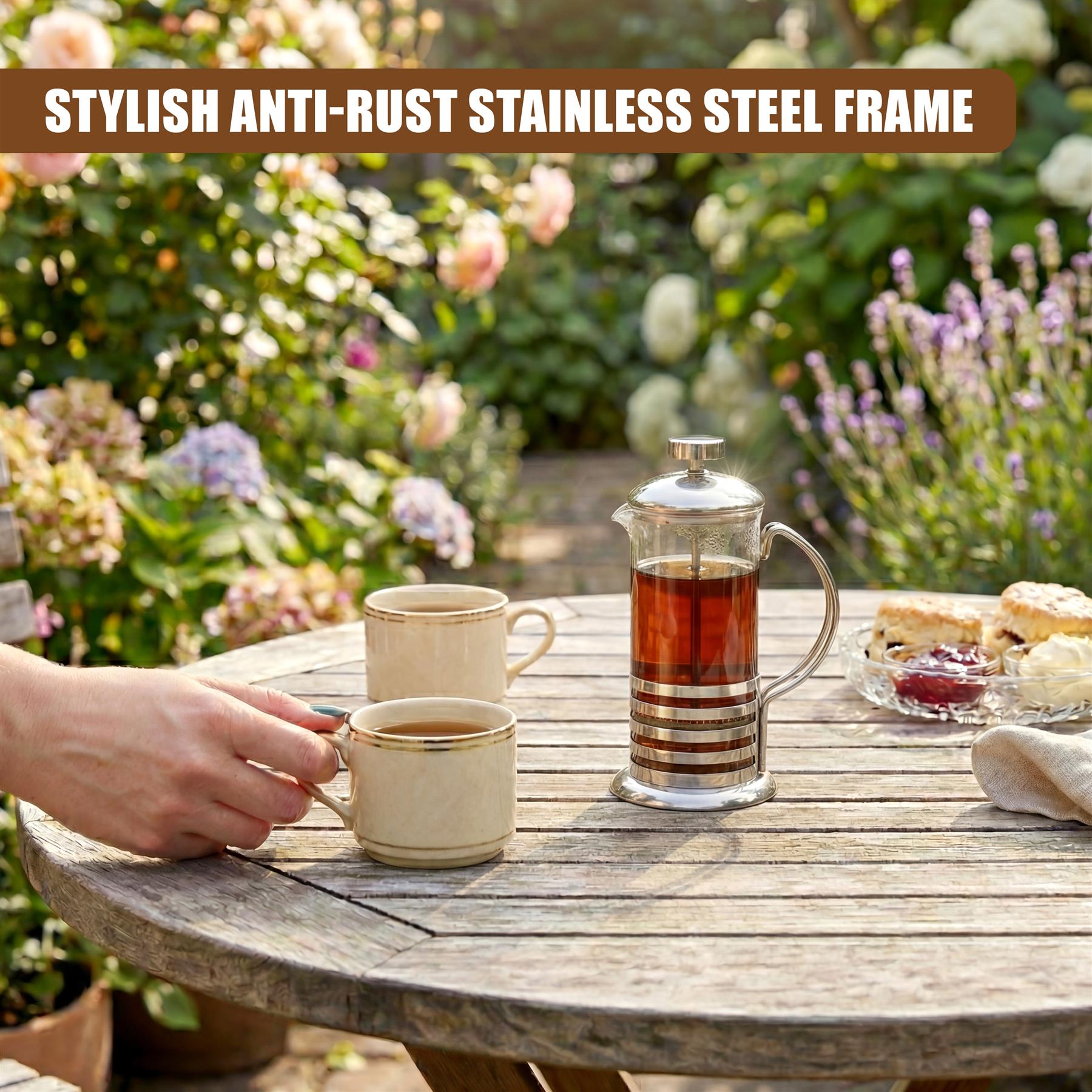 A stainless steel cafetiere and two ceramic mugs of coffee rest on a weathered wooden table.
