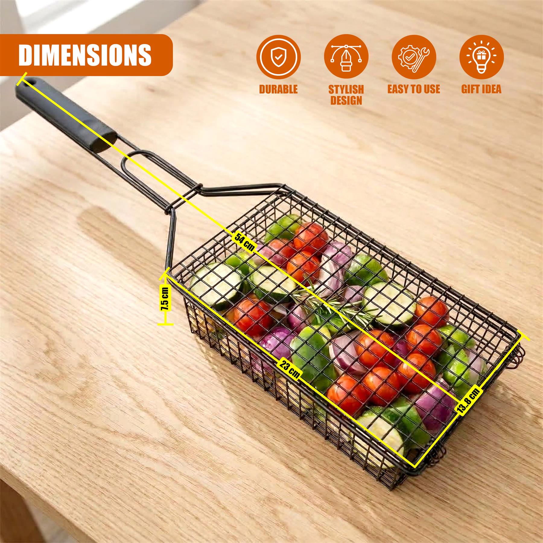 Black metal grilling basket filled with assorted vegetables rests on a wooden surface.