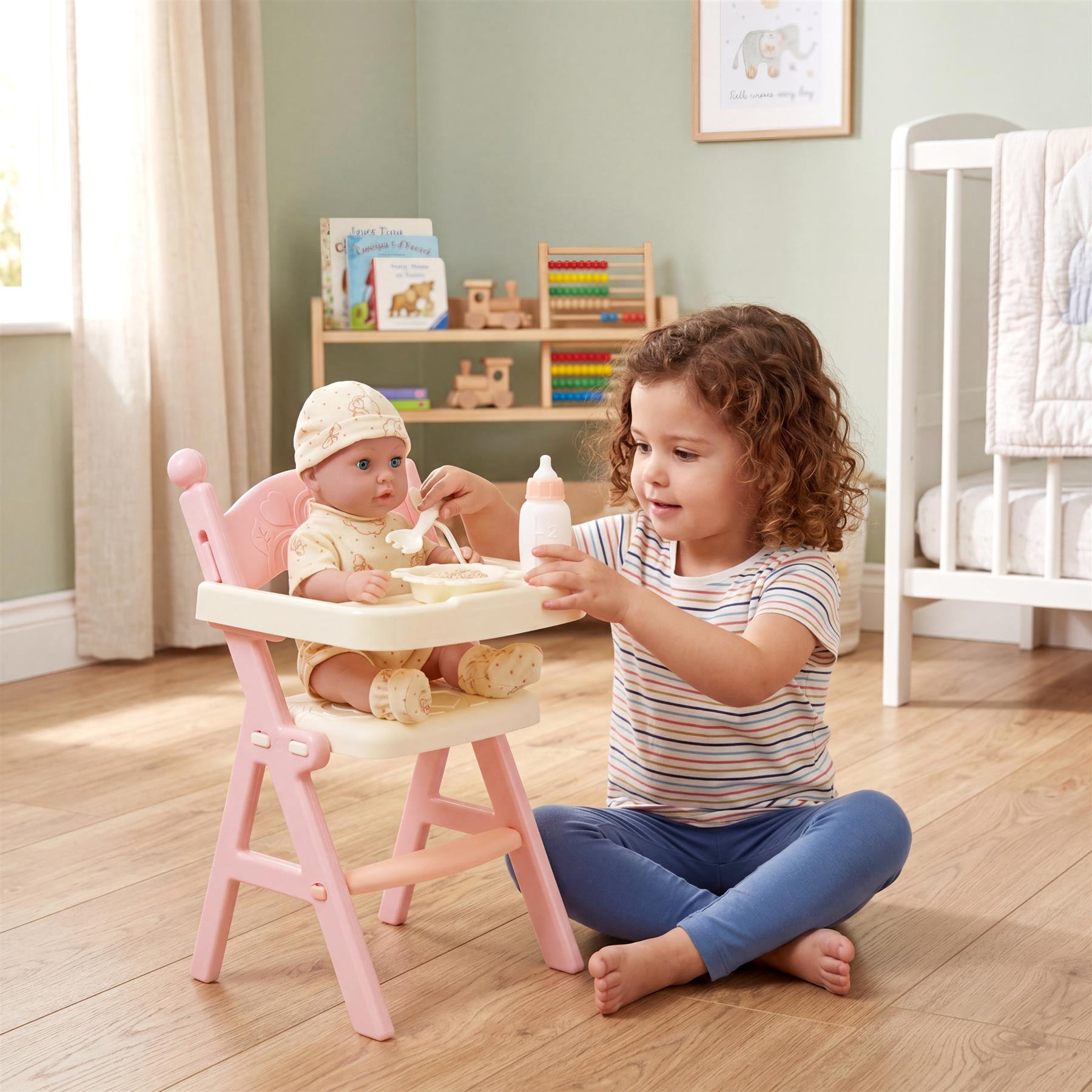 A doll sits in a pink high chair while another doll feeds it with a toy baby bottle.