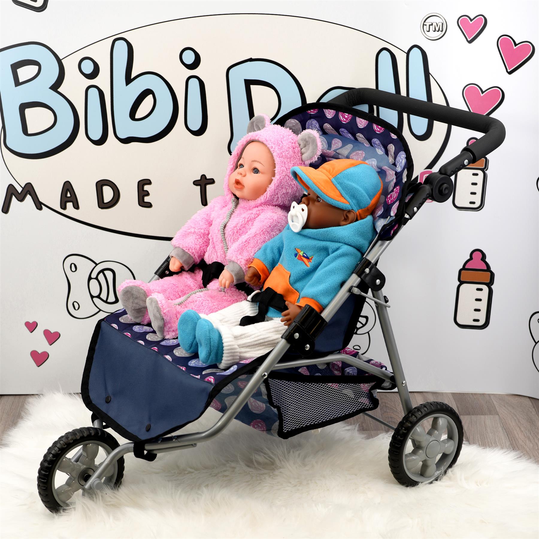 Blue and black stroller carrying two dolls; one in pink and one in blue clothes.