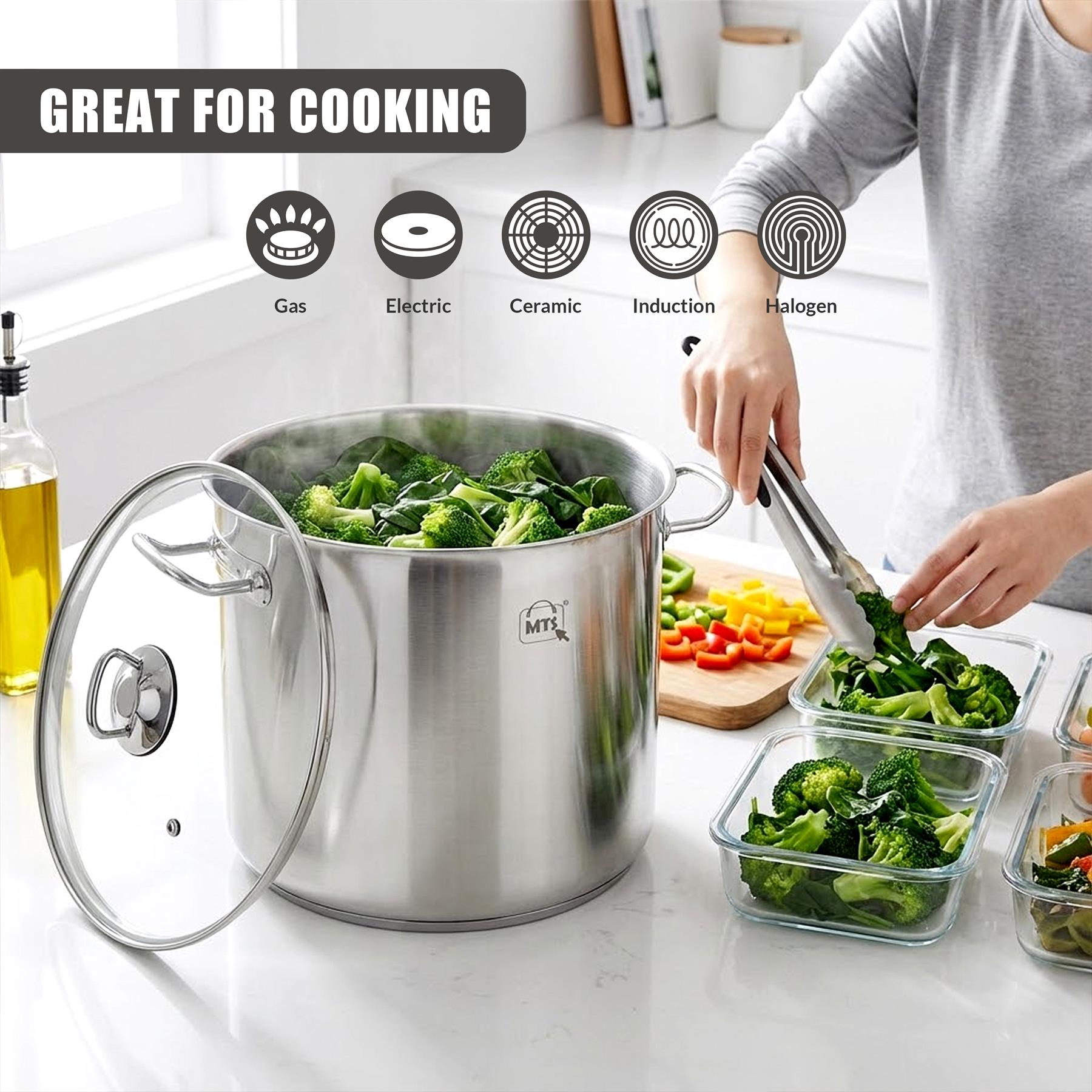 Large stainless steel stockpot with glass lid, containing broccoli being moved to a clear glass container.