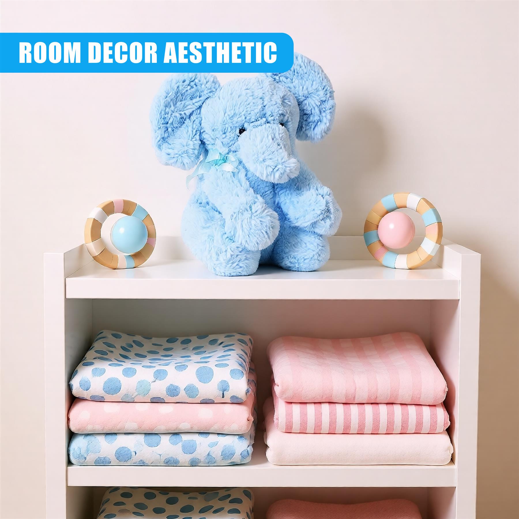 A white bookshelf with two shelves, featuring a soft blue elephant plush toy on the top shelf, surrounded by a few toys and a stack of folded baby blankets. - The Magic Toy Shop
