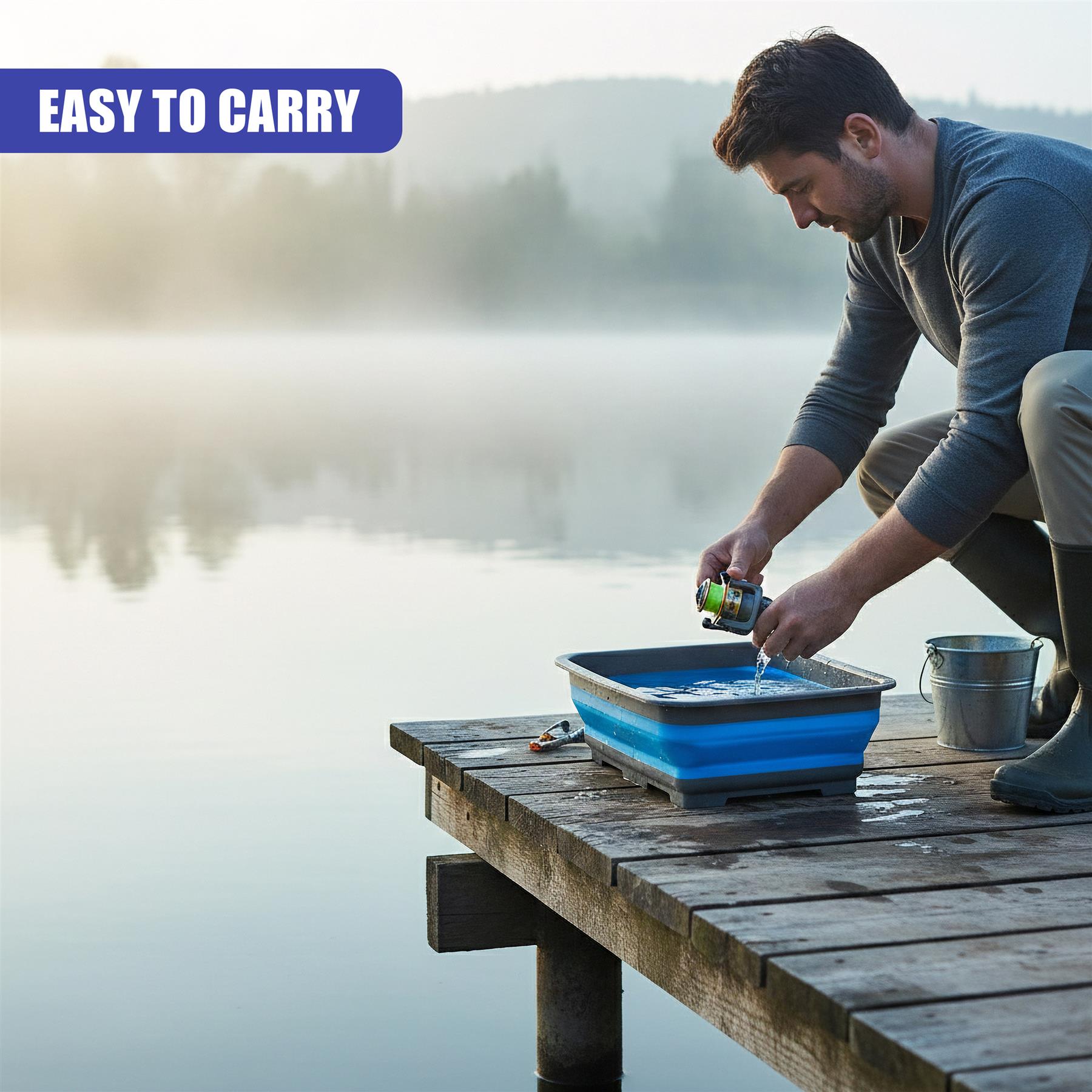 Man washes items in a foldable blue washing up bowl on a foggy wooden pier.