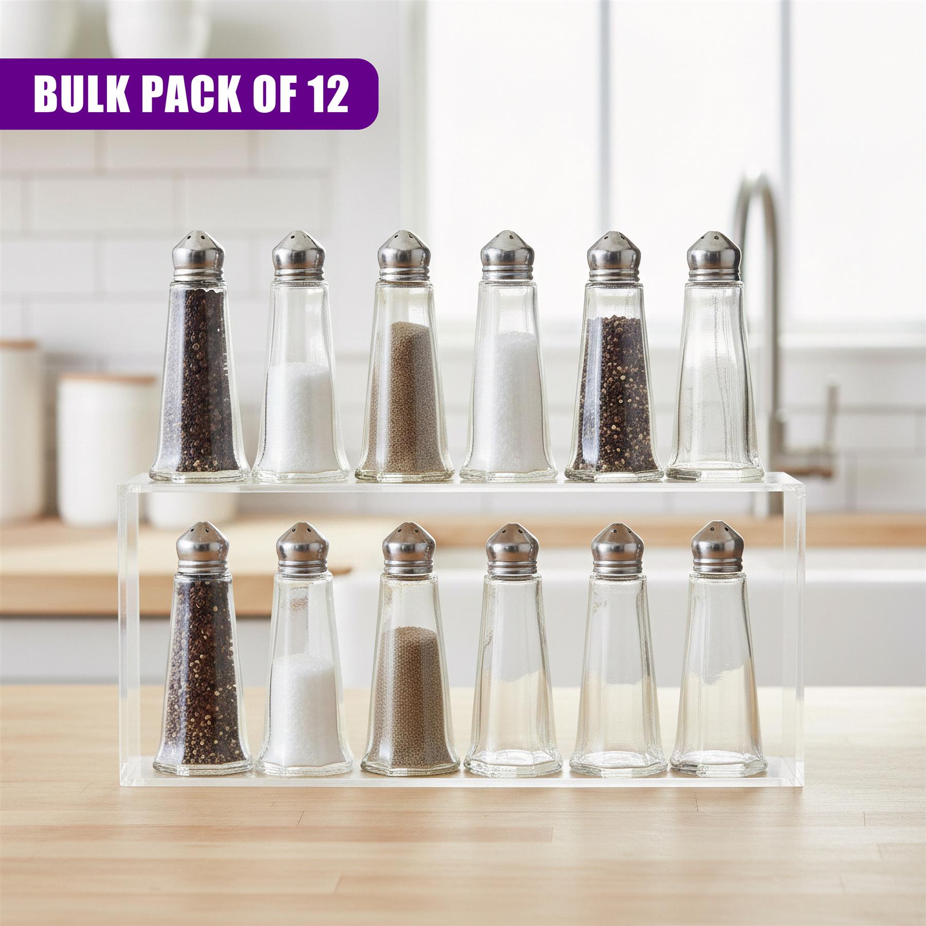 A set of twelve clear glass spice shakers, each containing a different seasoning, displayed in a rectangular storage box.