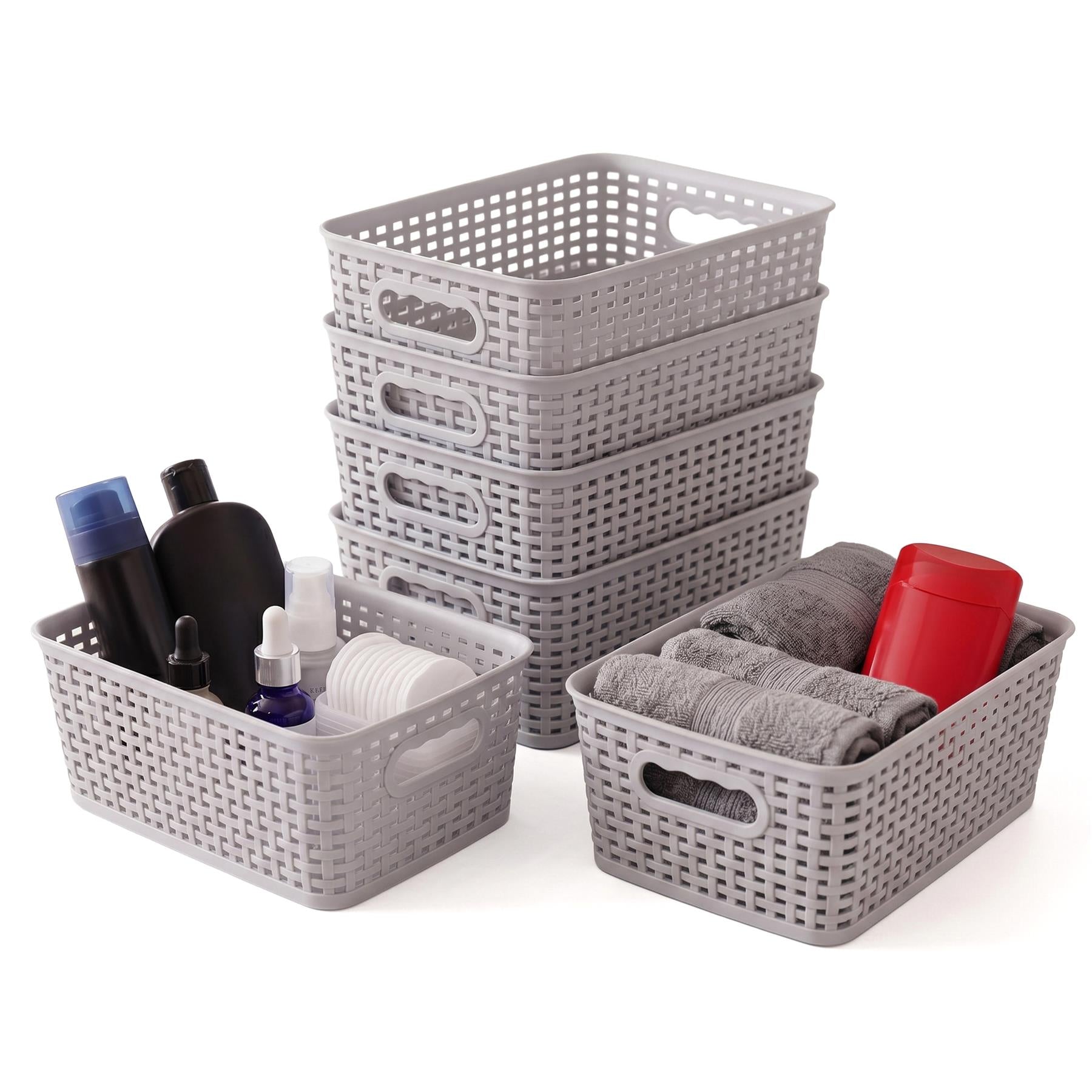 Grouping of gray plastic woven baskets containing soaps, folded towels, and bathroom care products.