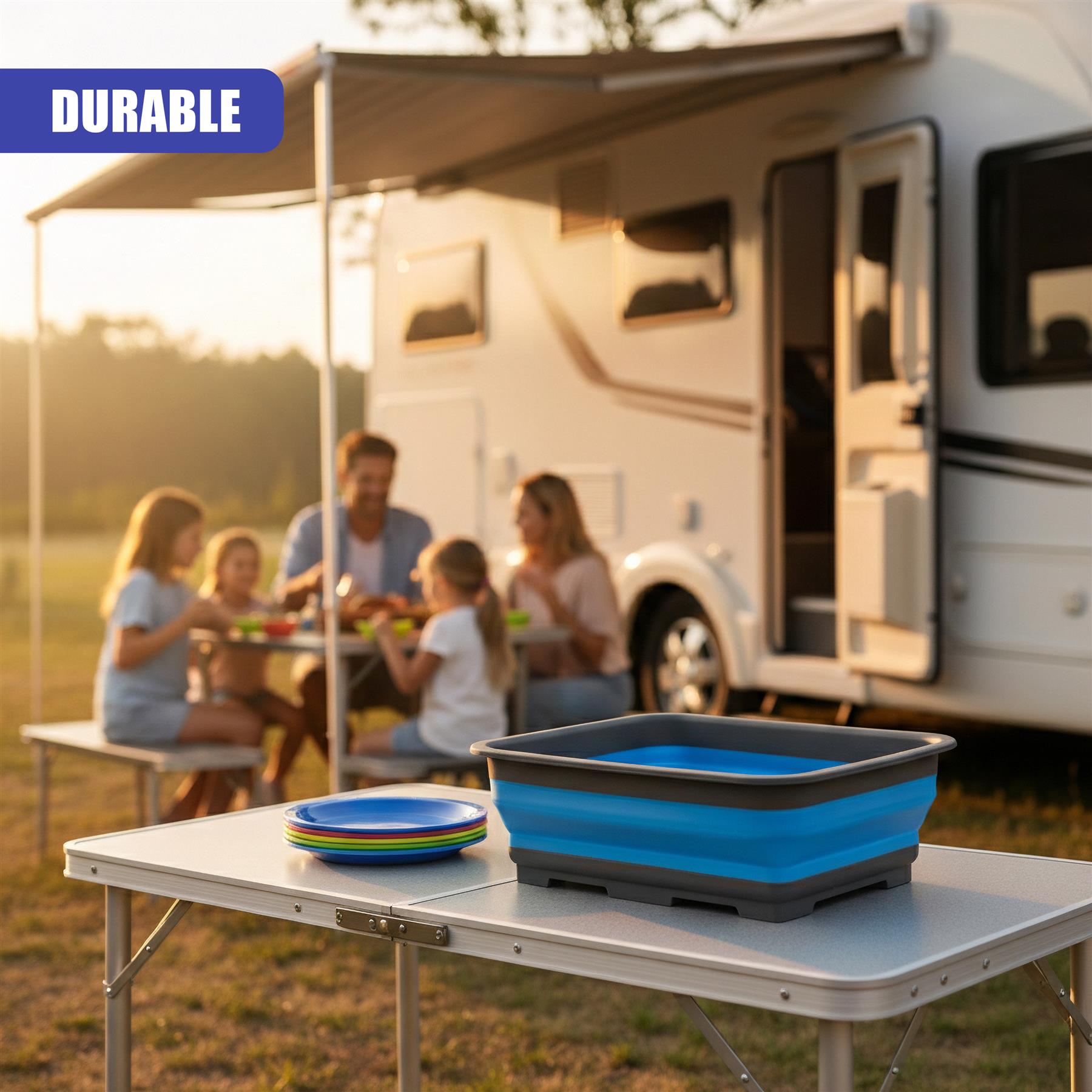 Blue and black foldable washing up bowl sits on a folding outdoor table in a sunny campsite setting.