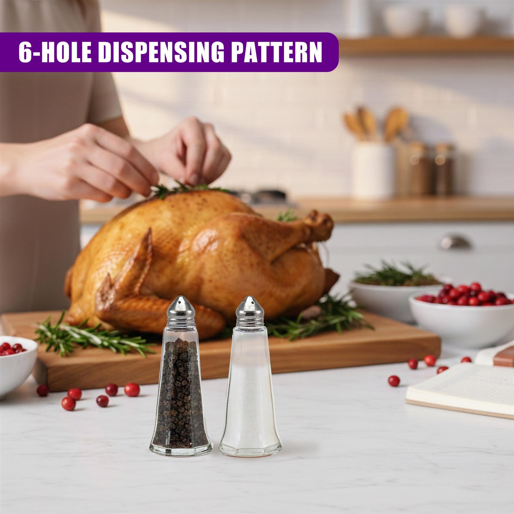 Two clear glass shakers holding black pepper and salt rest on a smooth white surface.