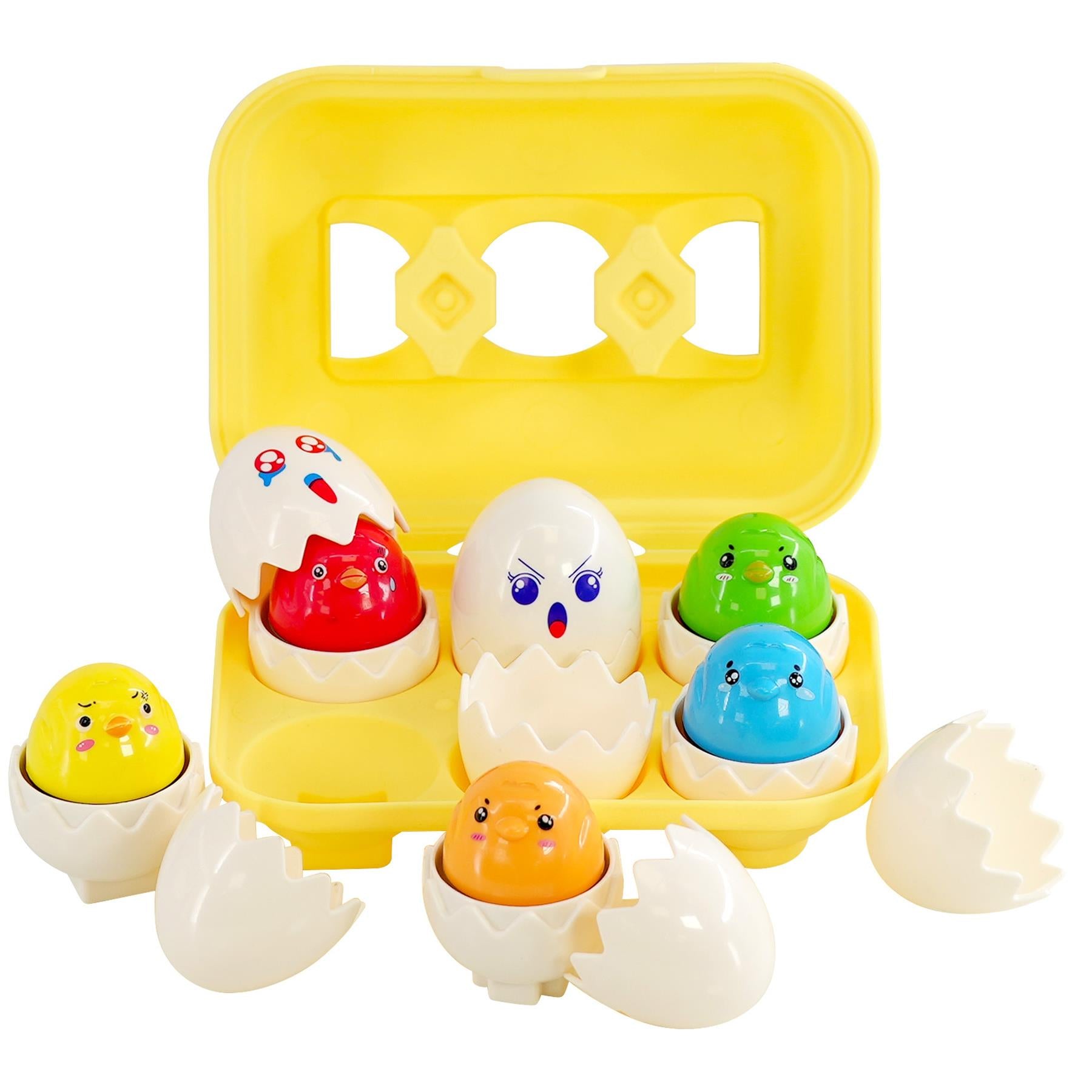 A yellow plastic egg tray holds multiple painted baby eggs and loose white shell pieces.