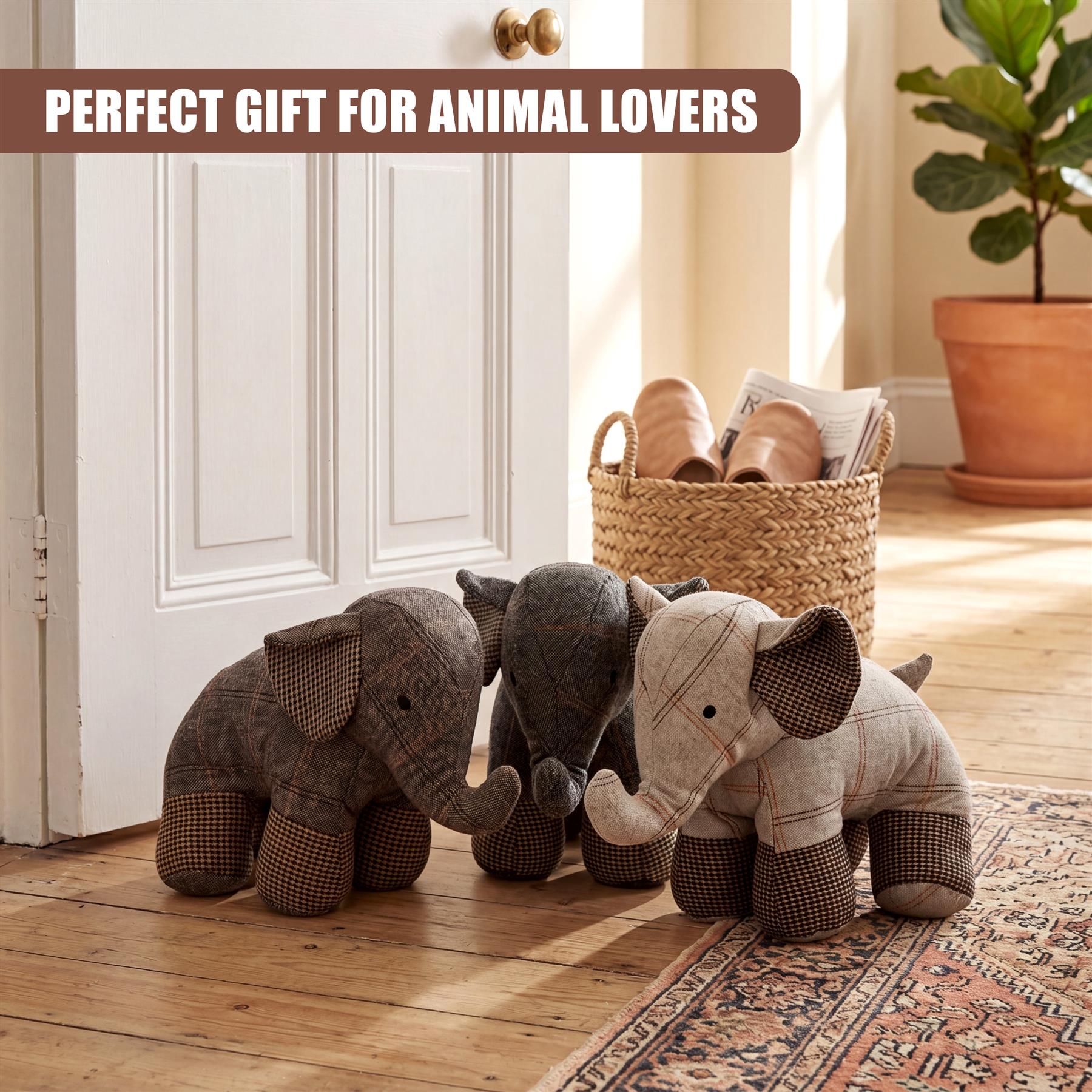 Three novelty elephant door stoppers, covered in plaid fabric, rest on a wooden floor.
